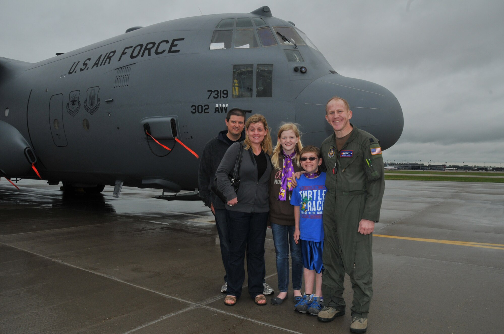 A.J. Neppl and his family of Apple Valley, Minn., get a tour of a C-130 from Air Force Reserve Captain Robert Wilson, a pilot with the 302nd Airlift Wing, Peterson Air Force Base, Colo.  They met for the first time at Minneapolis-St. Paul Air Reserve Station, almost 3 years after Capt. Wilson donated lifesaving bone marrow to the then 7 year old boy.  (U.S. Air Force Photo/Tech. Sgt. Bob Sommer)