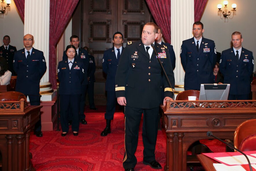 Senator Lou Correa, chairman of the California Senate Veterans Affairs Committee, and Maj. Gen. David Balwin, adjutant general for the California National Guard, honor seven Air National Guardsmen from the 129th Rescue Wing on the California Senate floor April 12 for their efforts in the successful rescue of two injured fishermen from a fishing vessel in international waters 500 miles off the coast of Acapulco, Mexico, on March 12, 2012. 