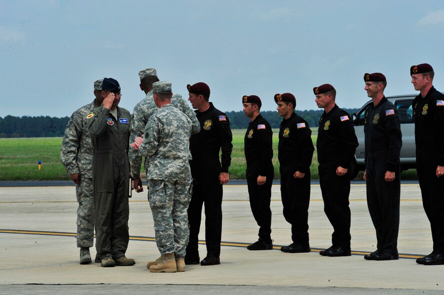 U.S. Air Force Col. Clay Hall, 20th Fighter Wing commander, is presented with a  golden baton by the U.S. Army Golden Knights parachute team at Shaw Air Force Base, S.C., during the 2012 Shaw Air Expo on May 5, 2012. Hall was presented the baton to signify the appreciation of the U.S. Army for Shaw's team work in the mission. (U.S. Air Force photo by Airman Nicole Sikorski/Released)