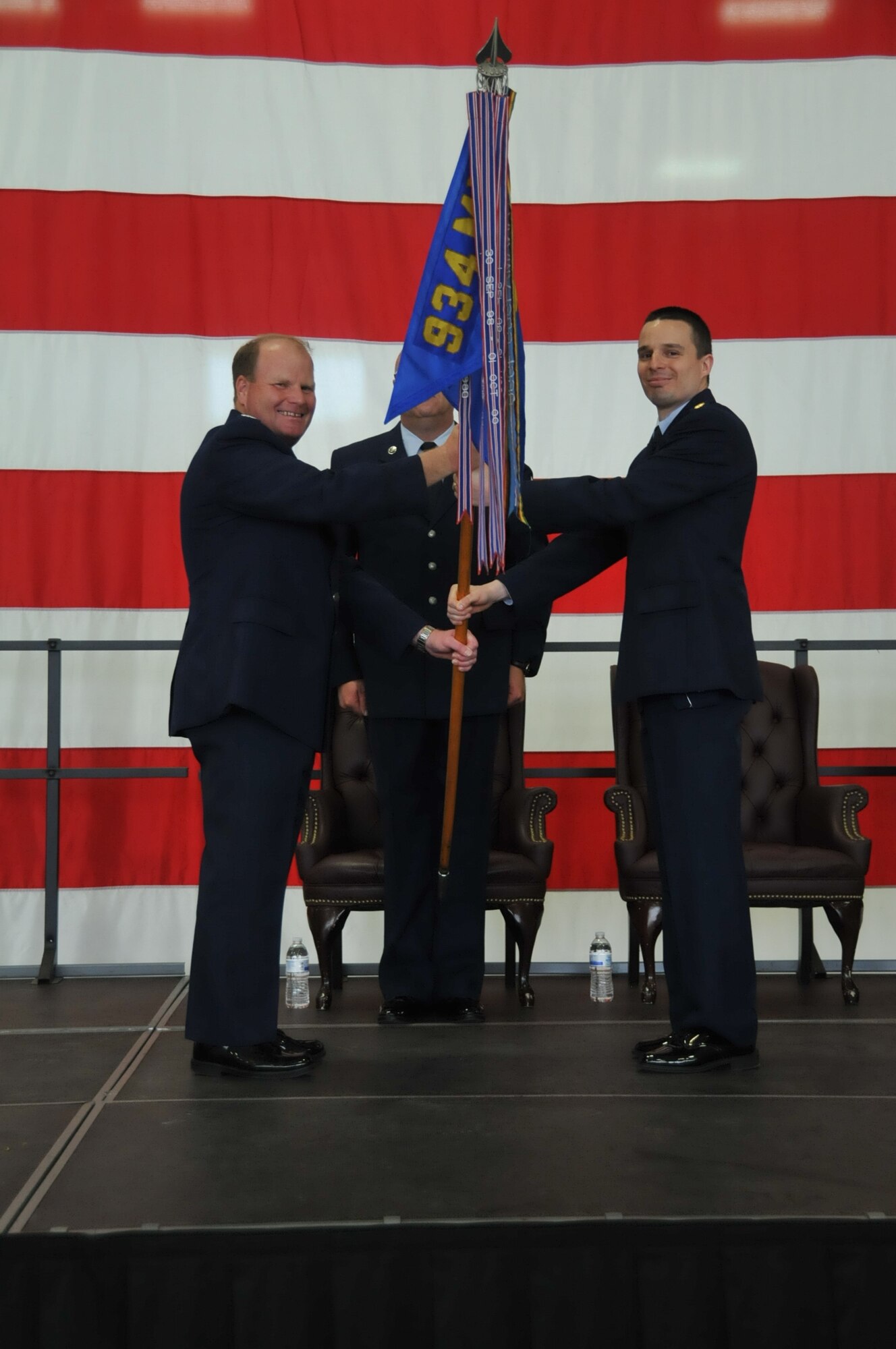 Colonel Cam LeBlanc passes the guidon to Major Andrew J. Staut.  Maj. Stuat assumed command of 934th Maintence Squadron May 6, at Minneapolis-St. Paul Air Reserve Station, Minn.  (U.S. Air Force photo/Tech. Sgt. Bob Sommer)