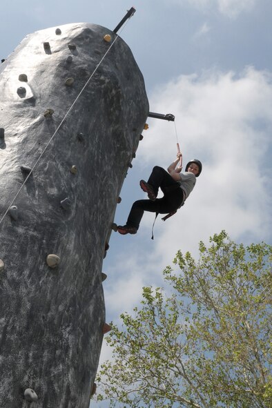 After making it to the top of the rock climbing wall, Student Flight member, Jana Randleman, makes her way back down to the ground outside of the Dining Facility of the 132nd Fighter Wing, Des Moines, Iowa on May 5, 2012.  Student Flight members are participating in a Basic Military Training prep confidence course.  (National Guard photo/Staff Sgt. Linda E. Kephart)(Released)  