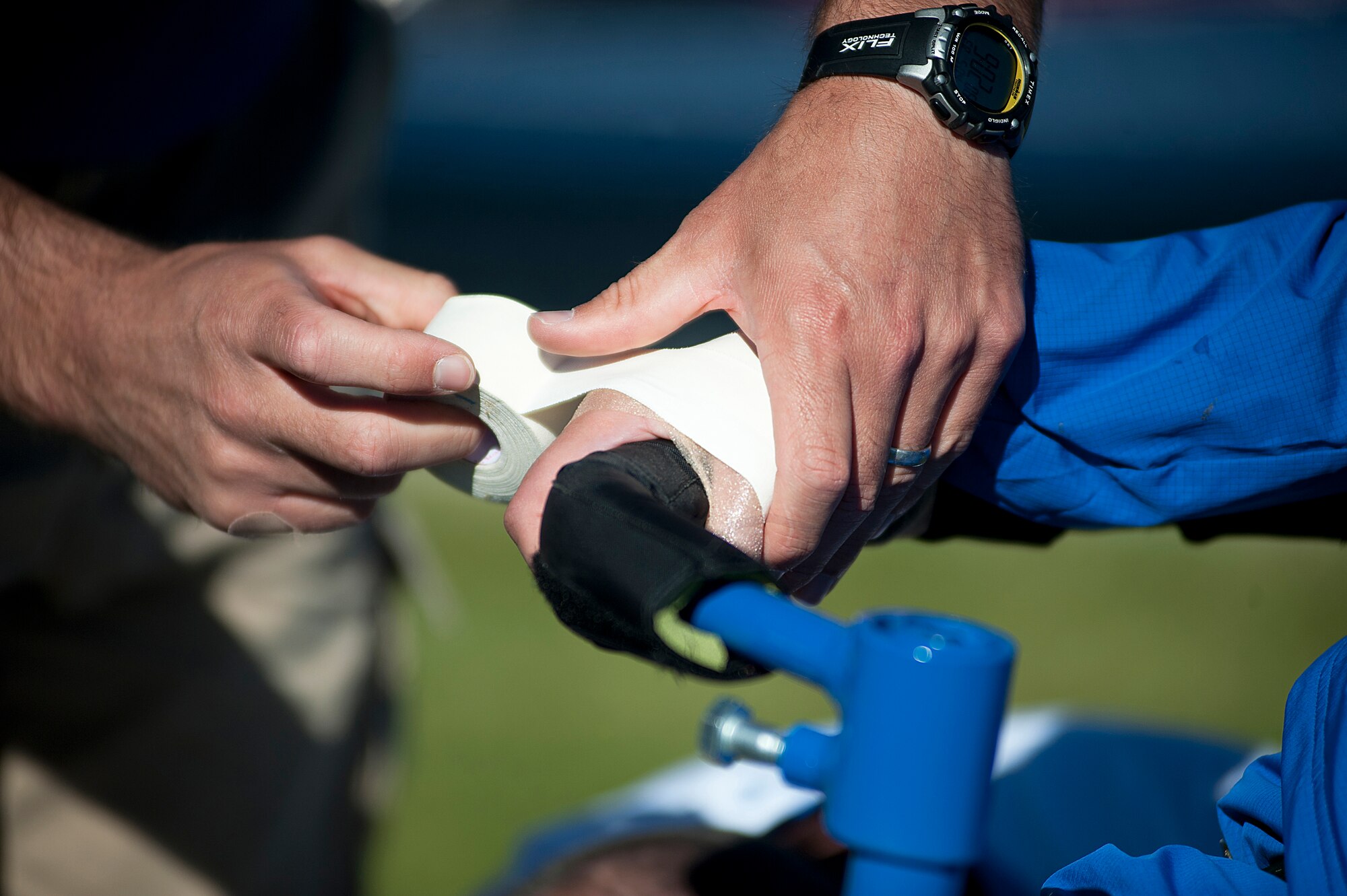 Ramina Oraha's hand is taped to her wheelchair by a coach as she takes part in the women's wheelchair shot put competition during Warrior Games 2012 at the U.S. Air Force Academy in Colorado Springs, Colo., May 4, 2012. Oraha is with the Air Force team. (U.S. Air Force photo by Val Gempis/Released)