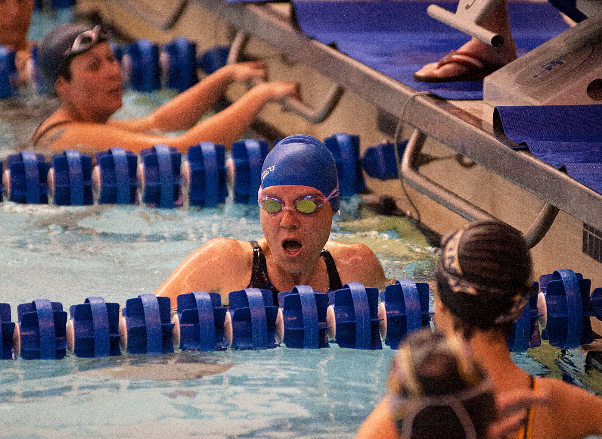 U.S. Air Force Tech. Sgt. Katie Robinson, center, looks at her time after finshing a heat during swimming competitions at Warrior Games 2012 at the U.S. Air Force Academy in Colorado Springs, Colo., May 5, 2012. Robinson is with the Air Force team. (U.S. Air Force photo by Val Gempis/Released)