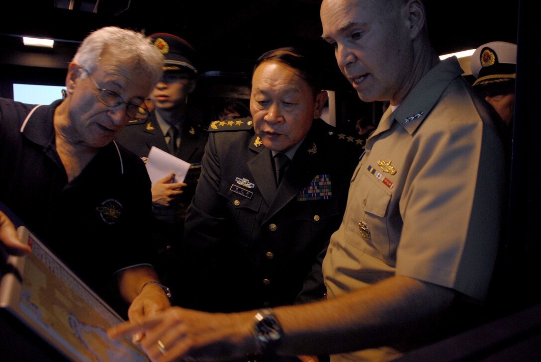 U.S. Navy Vice Adm. Richard W. Hunt, commander of U.S. Naval Surface Forces, discusses training capabilities with Chinese Minister of National Defense Gen. Liang Guanglie at the Navigation, Seamanship and Shiphandling Trainer in San Diego, May 5, 2012. 