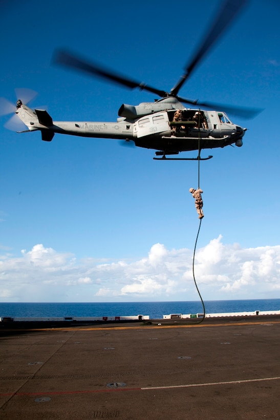 A reconnaissance Marine with Battalion Landing Team 3/1 descends down a thick, plaited rope rigged to a UH-1Y Huey flown by pilots with Marine Medium Helicopter Squadron 268 (Reinforced) onto USS Makin Island's flight deck here May 6. The landing team and the squadron are the ground-combat and aviation-combat elements, respectively, for the 11th Marine Expeditionary Unit. The unit embarked USS Makin Island, USS New Orleans and USS Pearl Harbor in San Diego Nov. 14 beginning a seven-month deployment to the Western Pacific, Horn of Africa and Middle East regions.