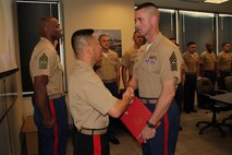 Brig. Gen. Daniel D. Yoo, commanding general of Western Recruiting Region and Marine Corps Recruit Depot San Diego, presents Recruiting Station Twin Cities Sgt. Maj. Sean P. Cox with a Navy and Marine Corps Commendation Medal with combat distinguishing device May 7 for heroic service in support of Operation Enduring Freedom while serving as the company first sergeant for Company E, 2nd Battalion, 8th Marine Regiment.