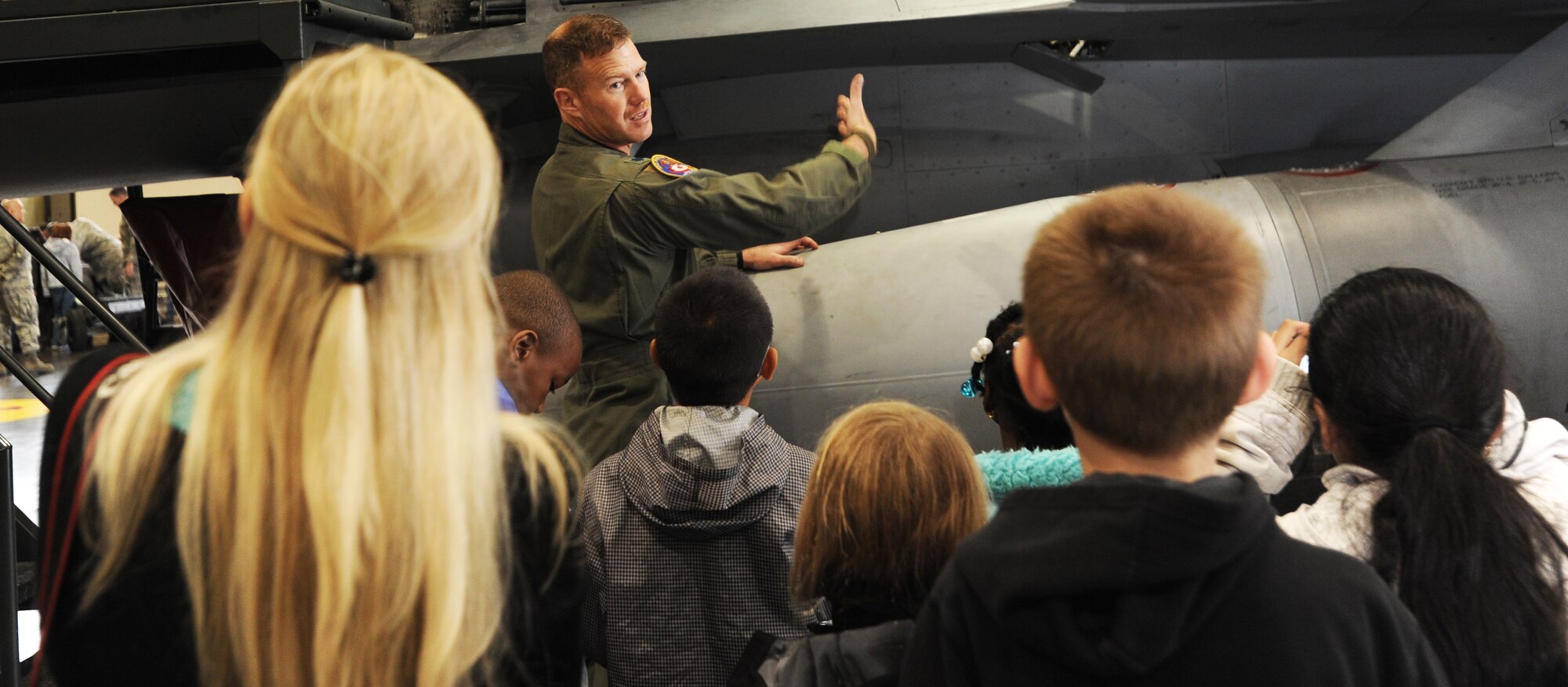 U.S. Air Force Lt. Col. Anthony Simpson, 35th Maintenance Group chief advance programs officer, explains the F-16 Fighting Falcon aircraft skeletal make-up and it’s unique qualities to Sollars Elementary School’s third grade students in Hangar 911 at Misawa Air Base, Japan, May 3, 2012. By visiting the six stations, students were educated on missiles, combat loads, bullets and projectiles, the F-16 Fighting Falcon aircraft and bomb lift trucks. (U.S. Air Force photo by Airman Kenna Jackson/Released)