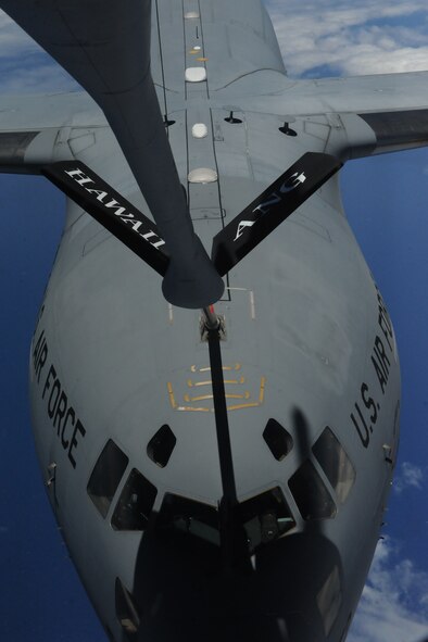 A C-17 Globemaster III from the 535th Airlift Squadron is refueled by a 154th Air Refueling Squadron KC-135 Stratotanker during a  Reserve Officer Training Corps incentive flight hosting cadets from U.S. Air Force ROTC Detachment 175 at the University of Hawaii May 4 at Joint Base Pearl Harbor-Hickam, Hawaii. The flight, which featured 7 cadets from both the U.S. Army and U.S. Air Force, served as an incentive flight for the cadets while simultaneously providing them a glimpse of the operational military. (U.S. Air Force photo by Staff Sgt. Nathan Allen)
