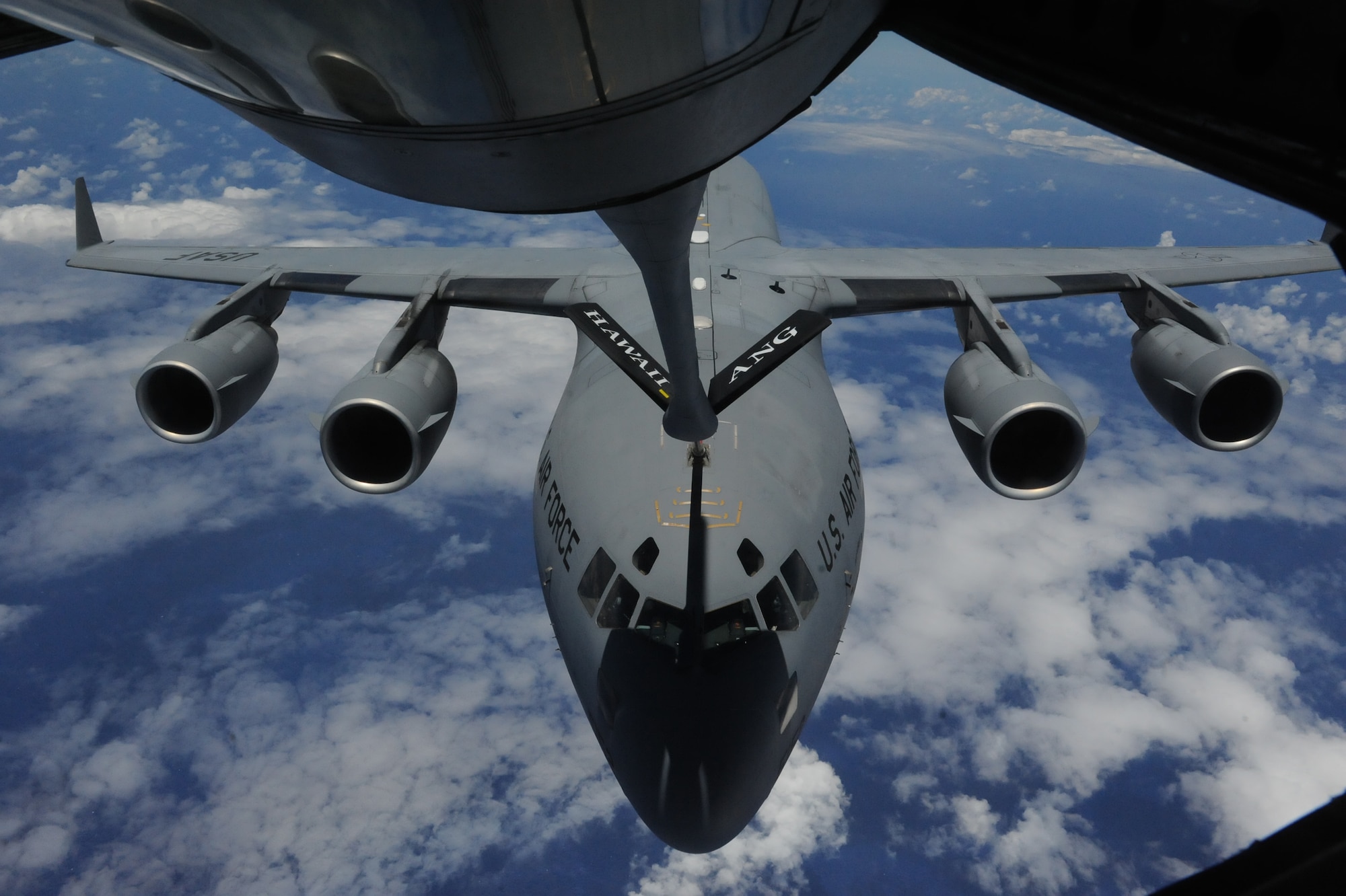 A C-17 Globemaster III from the 535th Airlift Squadron is refueled by a 154th Air Refueling Squadron KC-135 Stratotanker during a  Reserve Officer Training Corps incentive flight hosting cadets from U.S. Air Force ROTC Detachment 175 at the University of Hawaii May 4 at Joint Base Pearl Harbor-Hickam, Hawaii. The flight, which featured 7 cadets from both the U.S. Army and U.S. Air Force, served as an incentive flight for the cadets while simultaneously providing them a glimpse of the operational military. (U.S. Air Force photo by Staff Sgt. Nathan Allen)
