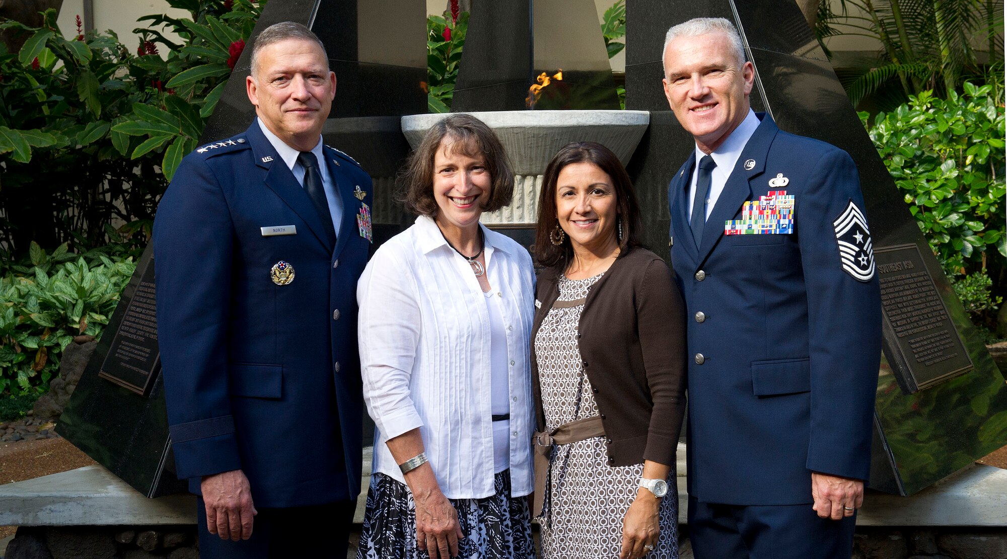 Gen. Gary North, Pacific Air Forces commander and his spouse Mrs. Shelley North (left), join PACAF Command Chief Master Sgt. Brooke McLean, and his spouse Mrs. Maria McLean (right), for a group photo at the Courtyard of Heroes, Headquarters Pacific Air Forces, Joint Base Pearl Harbor Hickam, Hawaii, April 23, 2012. The general, command chief, and PACAF’s outstanding Airmen of the year presided over the ceremony honoring those who died at Hickam Field, Dec. 7, 1941. (U. S. Air Force photo/Tech. Sgt. Jerome S. Tayborn)