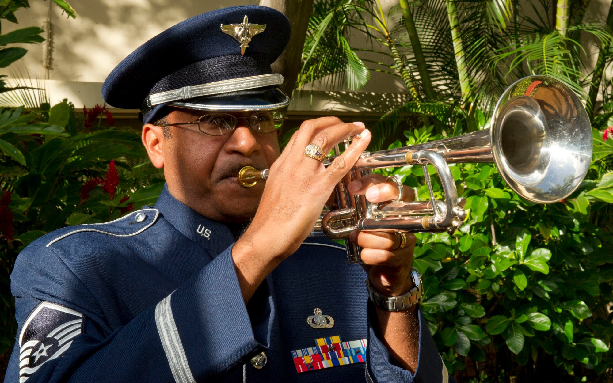 Master Sgt. Brian Hornbuckle, member of the Band of the Pacific, plays the ceremonial taps bugle on his trumpet at the Courtyard of Heroes, Headquarters Pacific Air Forces, Joint Base Pearl Harbor Hickam, Hawaii, April 23, 2012. Gen. Gary North, Pacific Air Forces commander and PACAF’s Command Chief Master Sgt. Brooke McLean joined the outstanding Airmen to honor those who died at Hickam Field, Dec. 7, 1941. (U.S. Air Force photo/Tech. Sgt. Jerome S. Tayborn) (U. S. Air Force photo/Tech. Sgt. Jerome S. Tayborn)