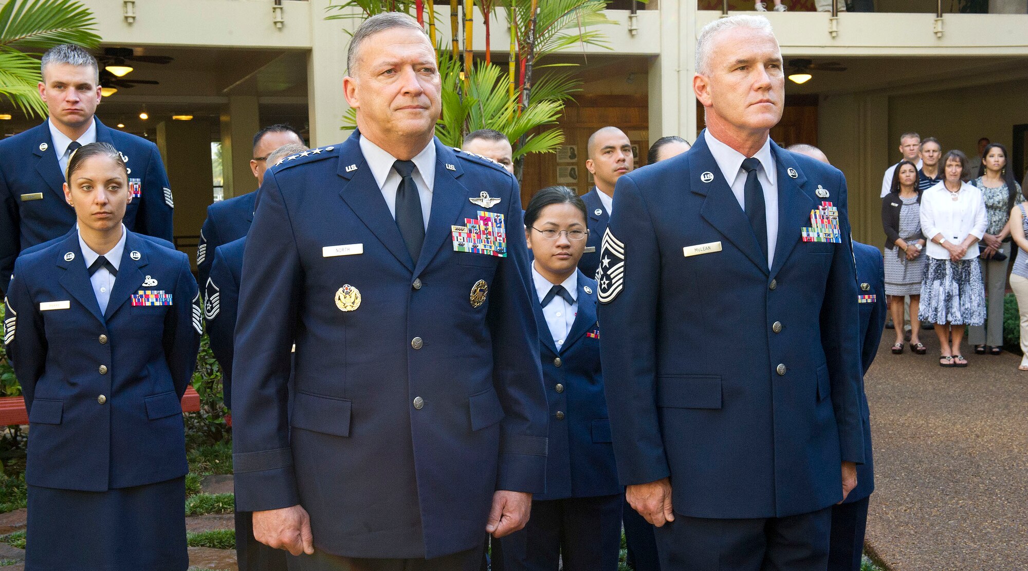 Gen. Gary North, Pacific Air Forces commander, and PACAF Command Chief Master Sgt. Brooke McLean stand at attention, during a wreath-laying ceremony, at the Courtyard of Heroes, Headquarters Pacific Air Forces, Joint Base Pearl Harbor Hickam, Hawaii, April 23, 2012. The general, command chief, and PACAF’s outstanding Airmen of the year presided over the ceremony honoring those who died at Hickam Field, Dec. 7, 1941. (U. S. Air Force photo/Tech. Sgt. Jerome S. Tayborn)