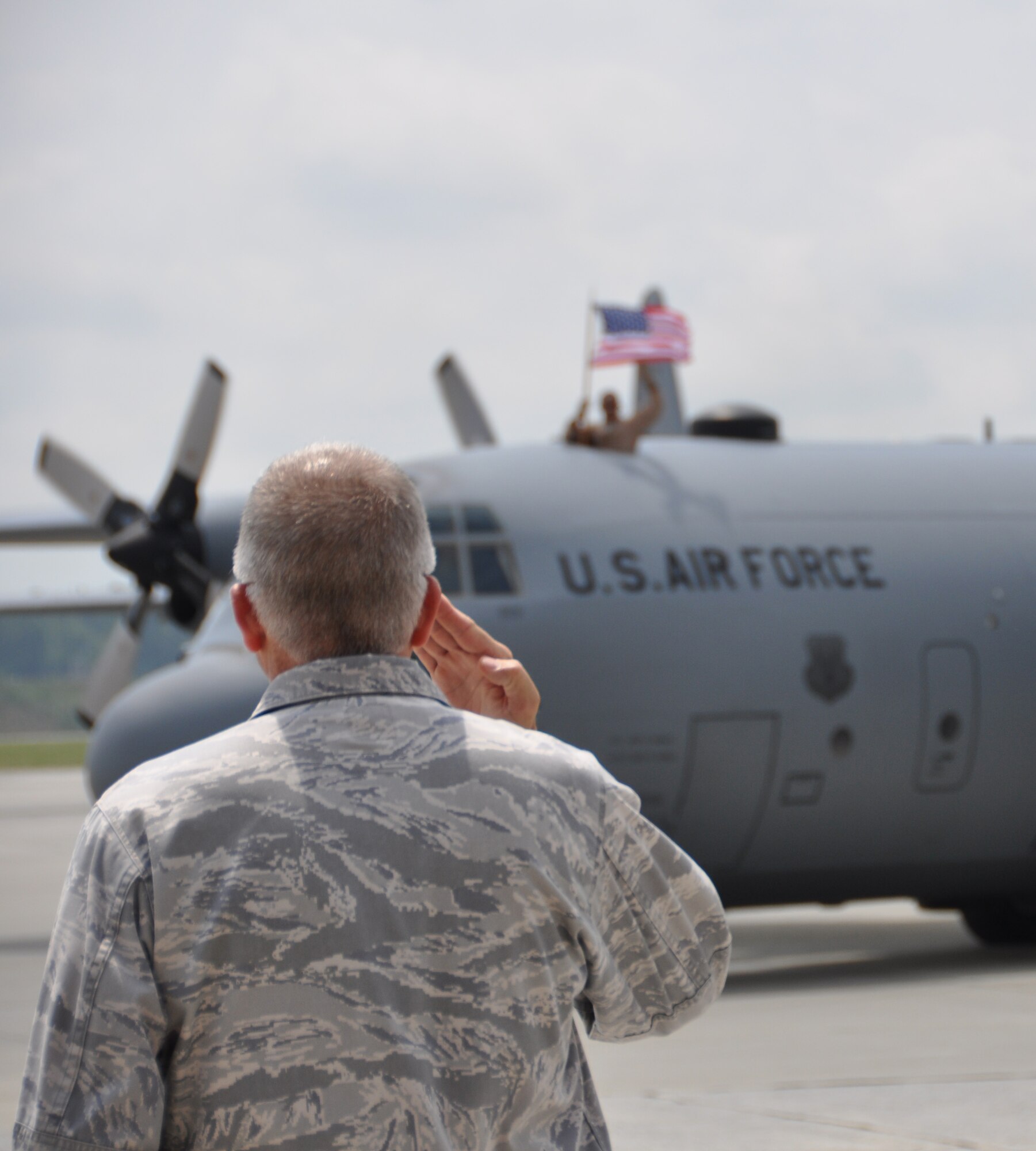 Col. Timothy E. Tarchick, 94th Airlift Wing commander, salutes Airman as they taxi to the runway on Dobbins Air Reserve Base during a send-off ceremony on May 7. Members of the 94th Airlift Wing deployed in support of operations in the Middle East. (U.S. Air Force photo/Airman 1st Class Elizabeth Gaston)