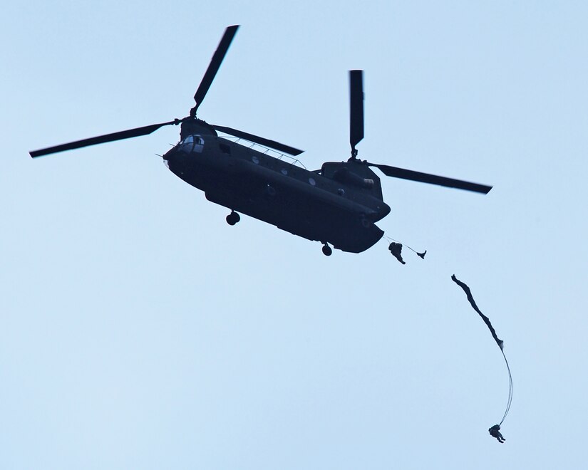 SOTO CANO AB, Honduras - A CH-47 Chinook, assigned to 1st Battalion, 228th Air Aviation Regiment at Joint Task Force-Bravo here, flies over the landing zone while Advanced Operation Base team member perform airborne operations April 30. Members of the AOB conduct this training quarterly in order to maintain airborne proficiency. (Photo/Martin Chahin)