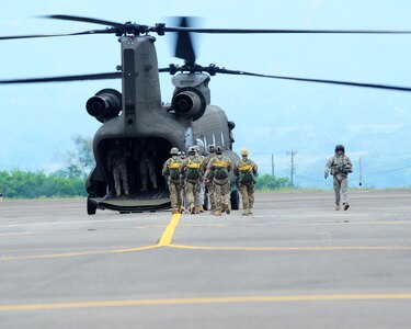 SOTO CANO AB, Honduras - Advanced Operation Base team members head to the back a CH-47 Chinook, assigned to 1st Battalion, 228th Air Aviation Regiment at Joint Task Force-Bravo here, to load up and then perform airborne operations April 30. Members of the AOB conduct this training quarterly in order to maintain airborne proficiency. (Photo/Martin Chahin)