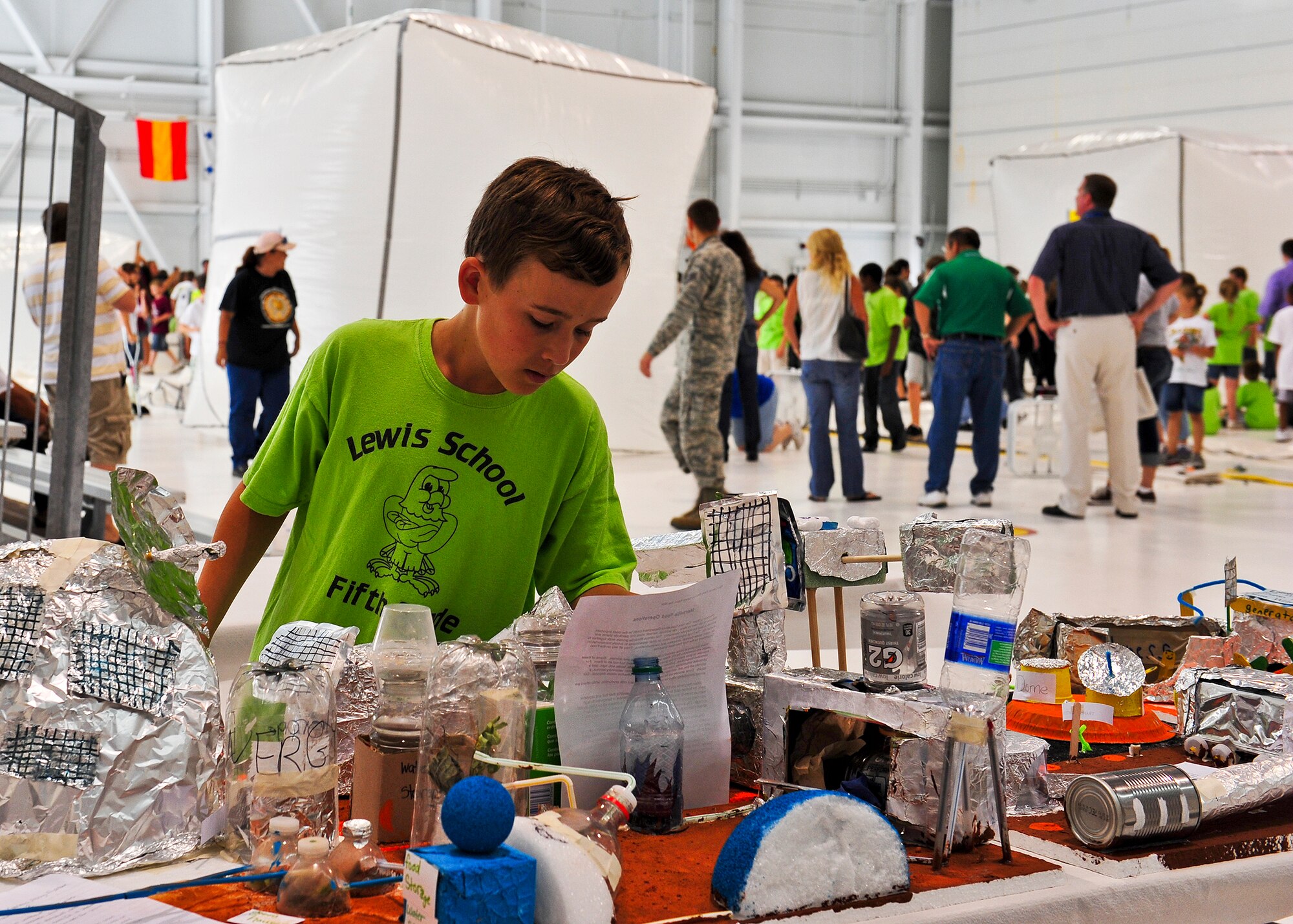 A student from Lewis Elementary School arranges a miniature mock-up of his Mars habitat just before judging May 4 at Eglin Air Force Base, Fla.  More than 450 students from Lewis, Longwood, Wright, Baker and Eglin Elementary Schools participated in the 17th annual Marsville event.  The program is designed to inspire students to enter the highly demanding career fields of science, technology, engineering and math. (U.S. Air Force photo/Randy Gon)