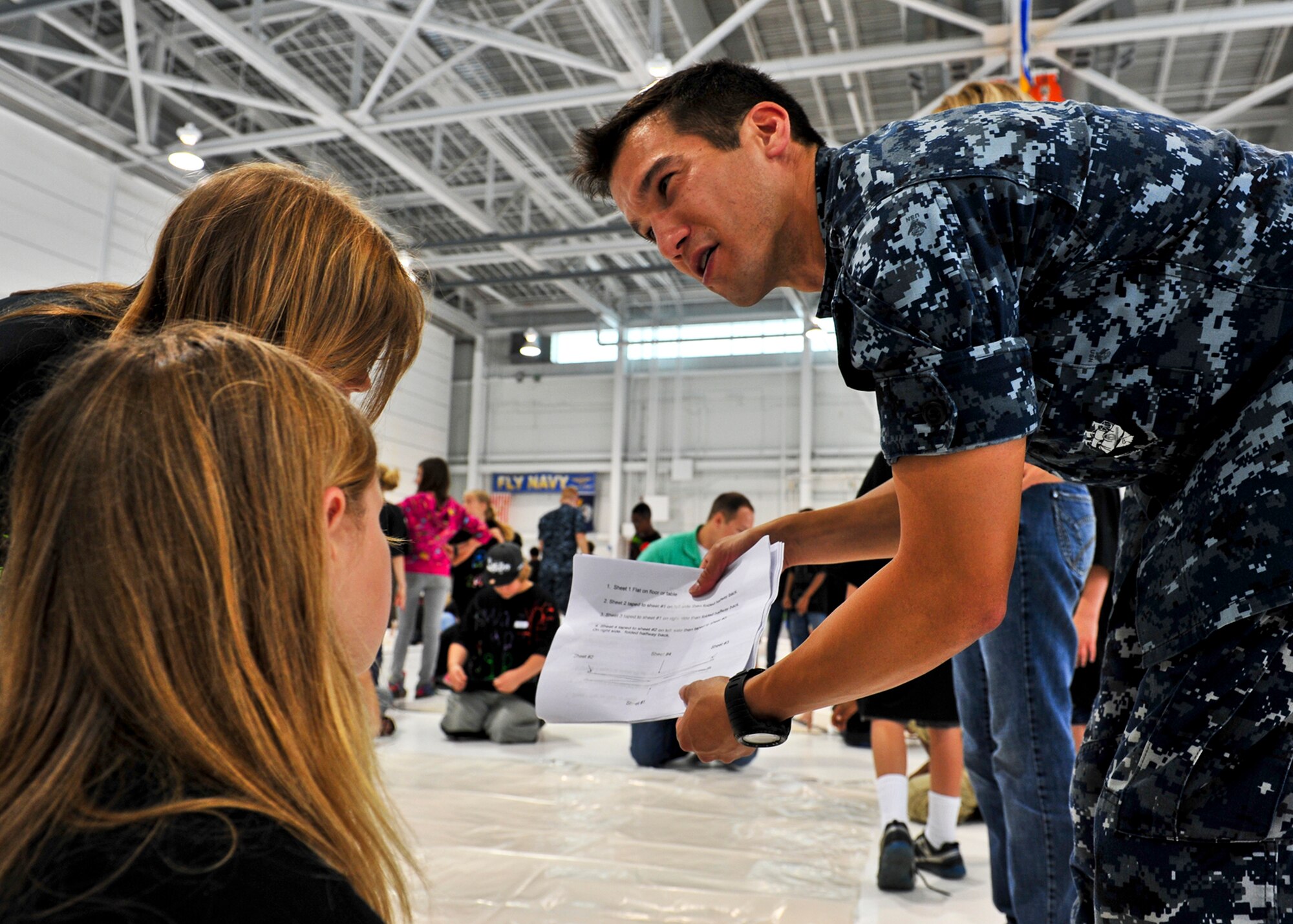 Petty Officer 2nd Class John Mahood, Navy Fighter Attack Squadron-101, provides instruction to students on designing Mars habitats during the 17th annual Marsville May 4 at Eglin Air Force Base, Fla.  The Marsville program is designed to inspire 5th grade students to enter the highly demanding career fields of science, technology, engineering and math. (U.S. Air Force photo/Randy Gon)