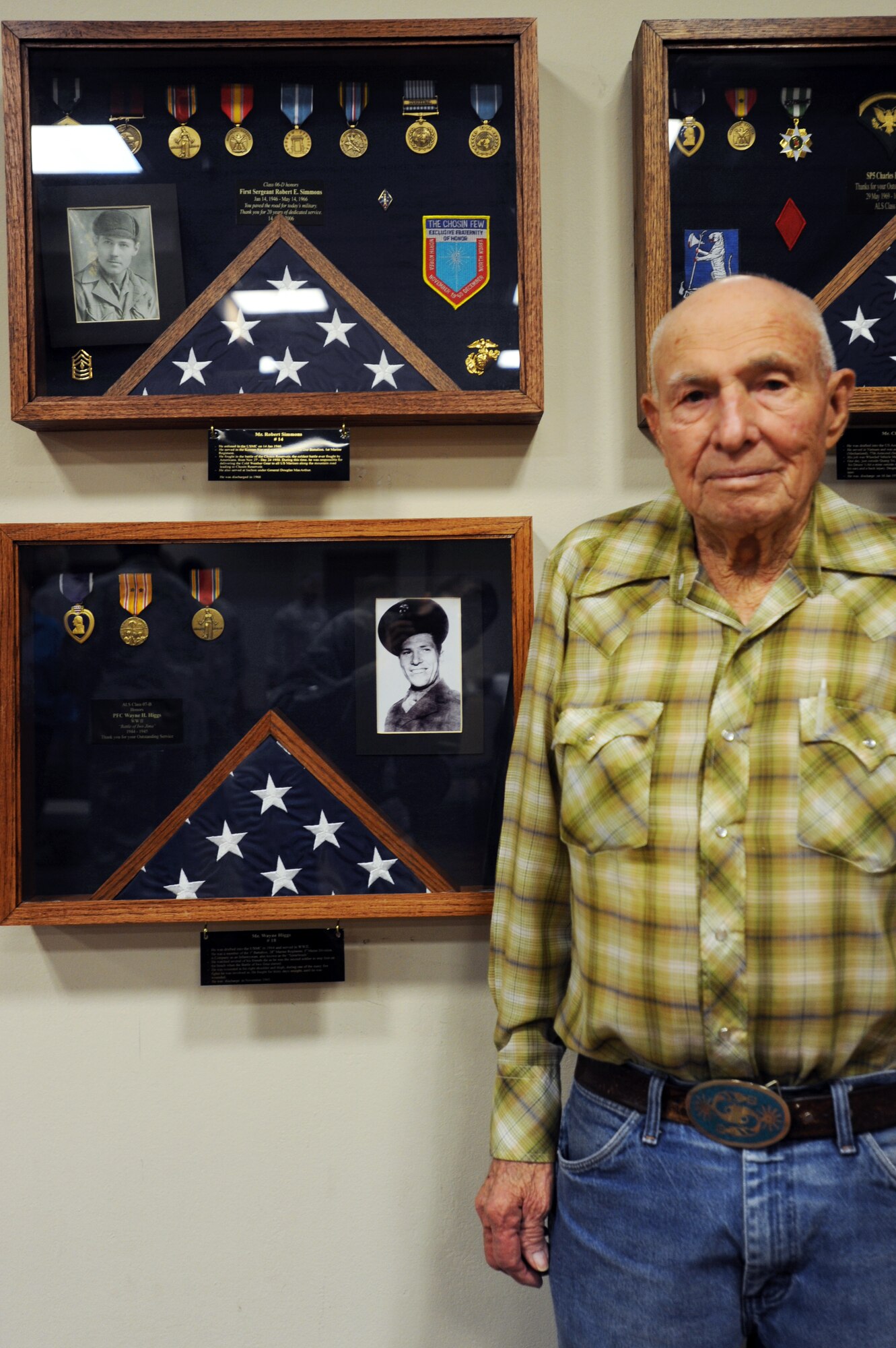 Wayne Higgs stands in front of his “Hall of Heroes” shadowbox in the during a recognition ceremony at Cannon Air Force Base, N.M., April 26, 2012. Higgs was an infantryman in the U.S. Marine Corp and fought in the Battle of Iwo Jima.  (U.S. Air Force photo by Senior Airman Jette Carr)