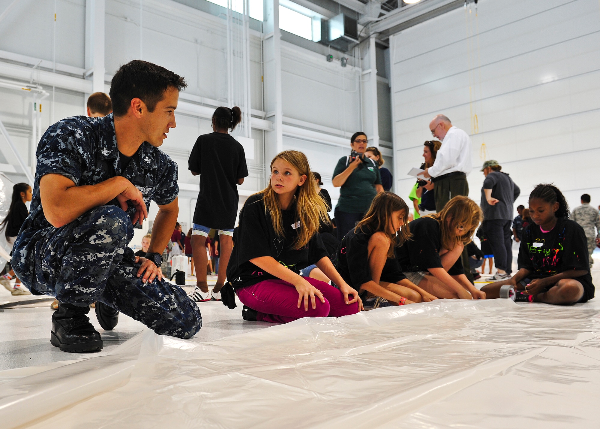 Petty Officer 2nd Class John Mahood, Navy Fighter Attack Squadron-101 and more than 100 military volunteers helped more than 450 students from five local area schools construct Mars habitats during the 17th annual Marsville event May 4 at Eglin Air Force Base, Fla.  The Marsville program is designed to inspire 5th grade students to enter the highly demanding career fields of science, technology, engineering and math. (U.S. Air Force photo/Randy Gon)