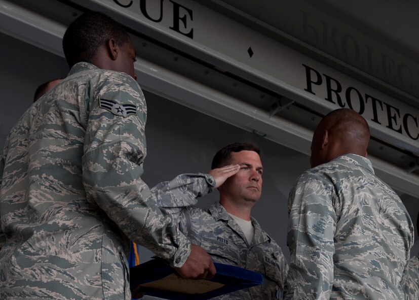 U.S. Air Force Col. Neal Robinson, 23d Maintenance Group commander, pins the Air Force Achievement Medal on Master Sgt. Benjamin Pitts,  723d Aircraft Maintenance Squadron, during the Clements McMullen Memorial Daedalian Weapons System Maintenance Trophy presentation at Moody Air Force Base, Ga., May 4, 2012. Distinguished visitor Lt. Gen. Judith Fedder, Headquarters U.S. Air Force, Washington, D.C., deputy chief of staff for logistics, installations and mission support, presented the trophy to Robinson representing all 23d MXG Airmen. (U.S. Air Force photo by Senior Airman Eileen Meier/Released)