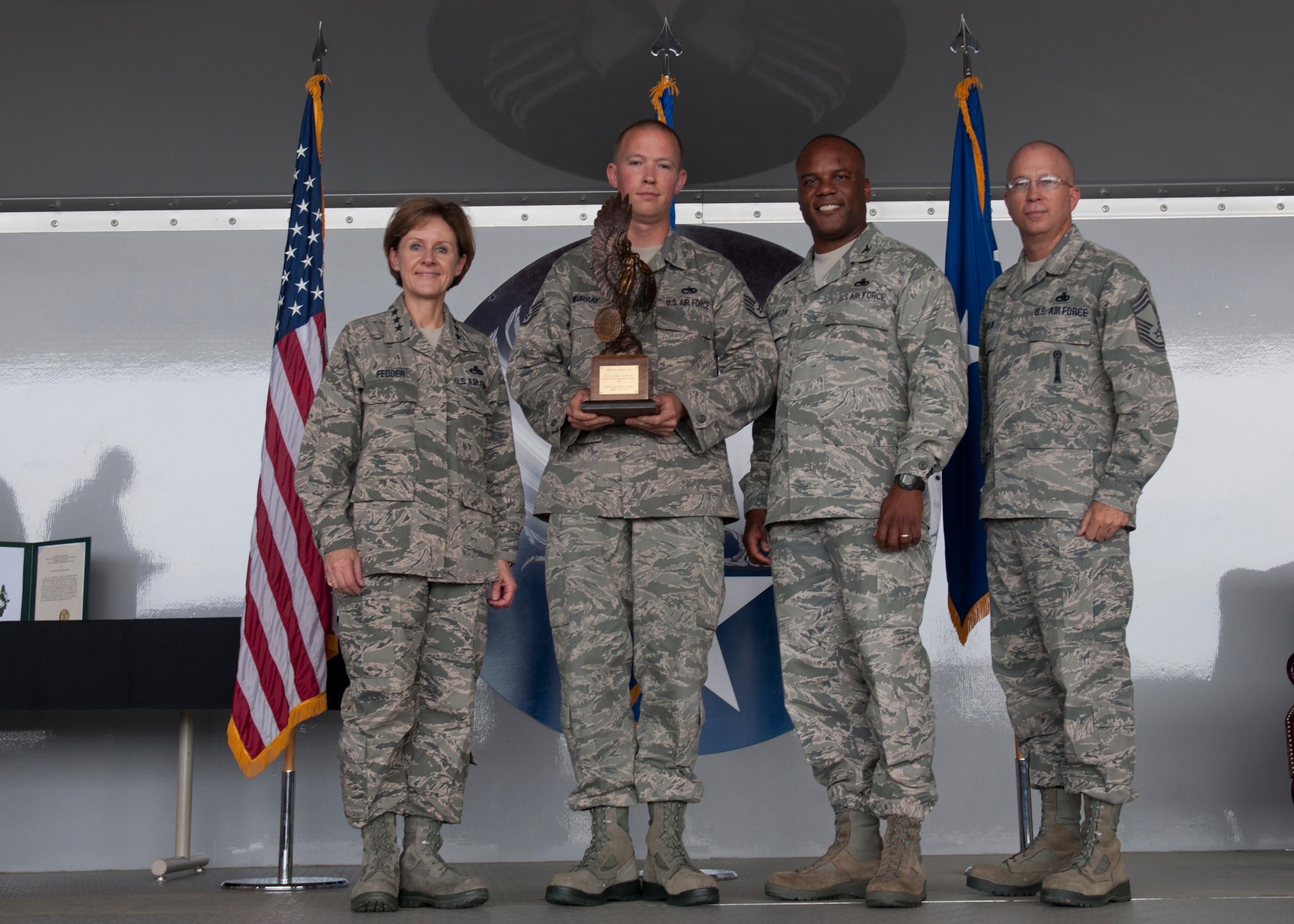 Airmen with the 23d Maintenance Group pose with U.S. Air Force Lt. Gen. Judith Fedder, Headquarters U.S. Air Force, Washington, D.C., deputy chief of staff for logistics, installations and mission support, after being presented the Clements McMullen Memorial Daedalian Weapons System Maintenance Trophy at Moody Air Force Base, Ga., May 4, 2012. The award recognizes the unit that has met the objective of providing safe, serviceable and available equipment for sustained use all over the world.  (U.S. Air Force photo by Senior Airman Eileen Meier/Released)
