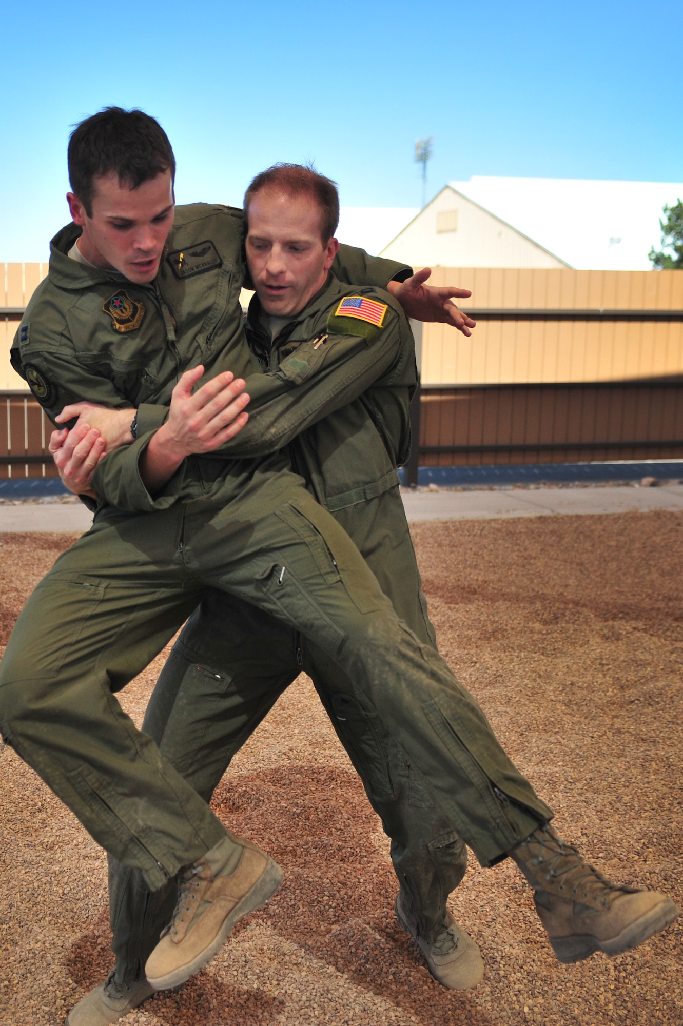 U.S. Air Force aircrew members practice take-down technique against on each other during a specialized Survival, Evasion, Resistance, and Escape lesson Cannon Air Force Base, N.M., May 2, 2012. SERE training is necessary for select Cannon Air Force Base, N.M., personnel to maintain mission-ready status. (U.S. Air Force photo by Airman 1st Class Alexxis Pons Abascal)  