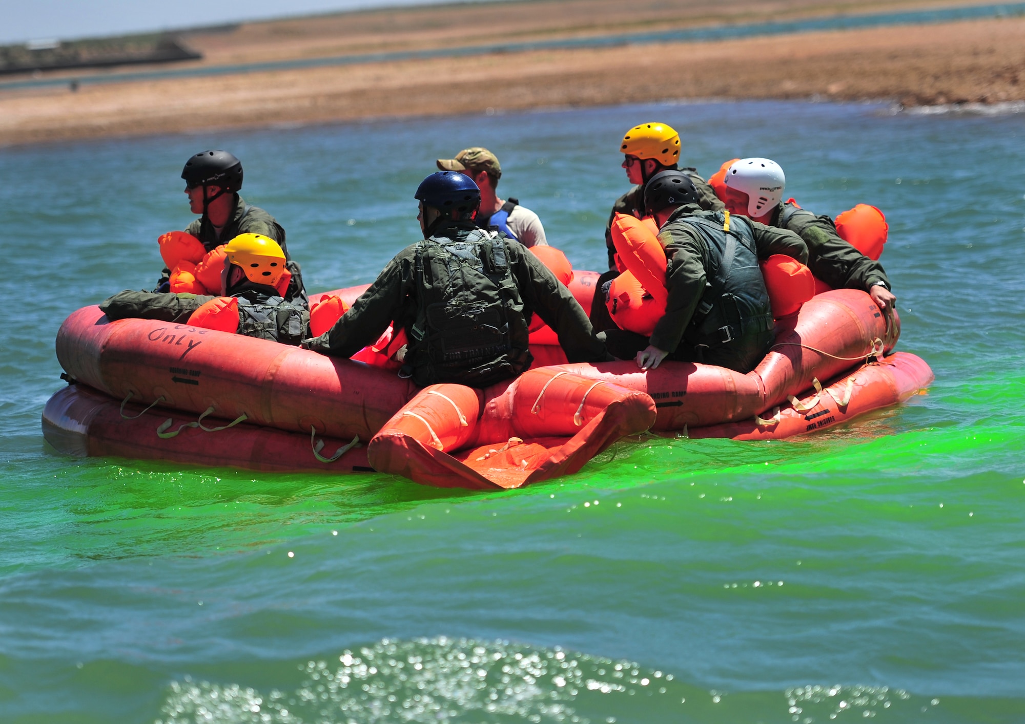 U.S. Air Force aircrew members drift in a large life raft awaiting their turn on the single-man life raft during a water survival course at Ute Lake, N.M., May 1, 2012. SERE training is necessary for select Cannon Air Force Base, N.M., personnel to maintain mission-ready status. (U.S. Air Force photo by Airman 1st Class Alexxis Pons Abascal)  