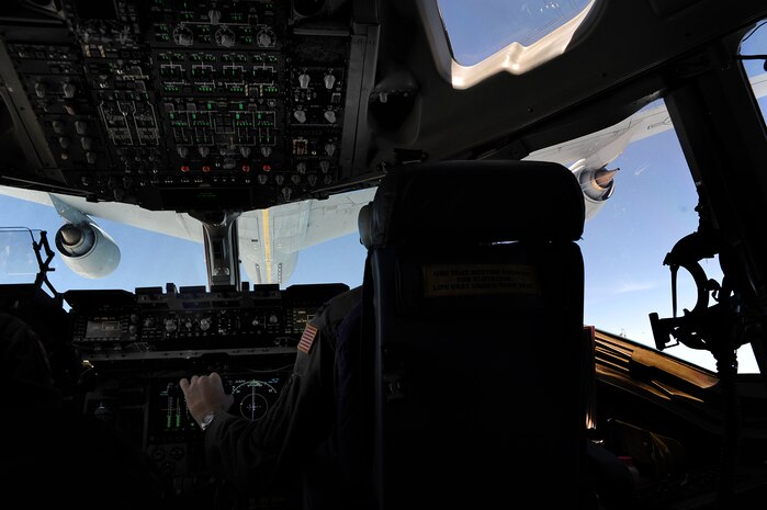 Capt. James Marceletti III, along with Capt. Andrew Mickles and Capt. Matthew Benza fly an in-flight refueling mission May 2. The flight took place on a C-17 Globemaster III. A KC-135 tanker refueled the C-17 in mid-air, allowing the receiving aircraft to remain airborne longer, extending its range or loiter time on station. Marceletti, Mickles and Benza are pilots with the 15th Airlift Squadron, 437th Airlift Wing. (U.S. Air Force photo/ Airman 1st Class Ashlee Galloway)