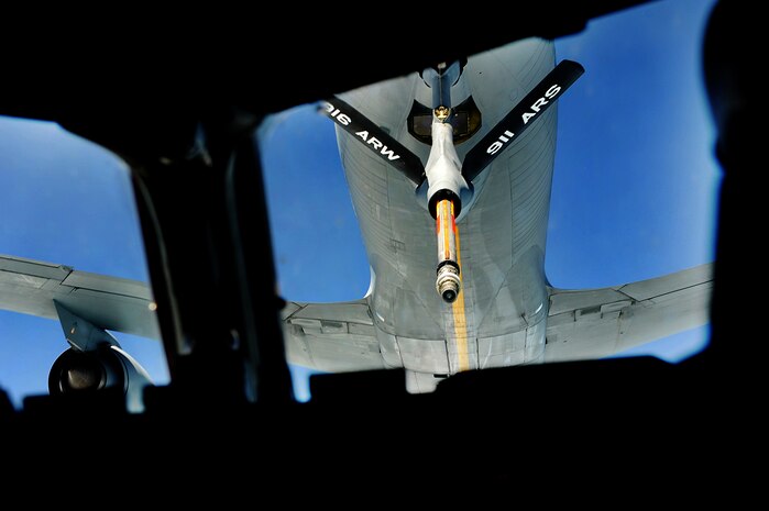 Capt. James Marceletti III, along with Capt. Andrew Mickles and Capt. Matthew Benza fly an in-flight refueling mission May 2. The flight took place on a C-17 Globemaster III. A KC-135 tanker refueled the C-17 in mid-air, allowing the receiving aircraft to remain airborne longer, extending its range or loiter time on station. Marceletti, Mickles and Benza are pilots with the 15th Airlift Squadron, 437th Airlift Wing. (U.S. Air Force photo/ Airman 1st Class Ashlee Galloway)