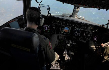 Capt. Andrew Mickles and Capt. James Marceletti III fly an in-flight refueling mission May 2. The flight took place on a C-17 Globemaster III. A KC-135 tanker refueled the C-17 in mid-air, allowing the receiving aircraft to remain airborne longer, extending its range or loiter time on station. Mickles and Marceletti are pilots with the 15th Airlift Squadron, 437th Airlift Wing. (U.S. Air Force photo/ Airman 1st Class Ashlee Galloway)