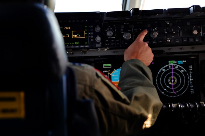 Capt. Matthew Benza flies an in-flight refueling mission May 2. The flight took place on a C-17 Globemaster III. A KC-135 tanker refueled the C-17 in mid-air, allowing the receiving aircraft to remain airborne longer, extending its range or loiter time on station. Benza is a pilot with the 15th Airlift Squadron, 437th Airlift Wing. (U.S. Air Force photo/ Airman 1st Class Ashlee Galloway)