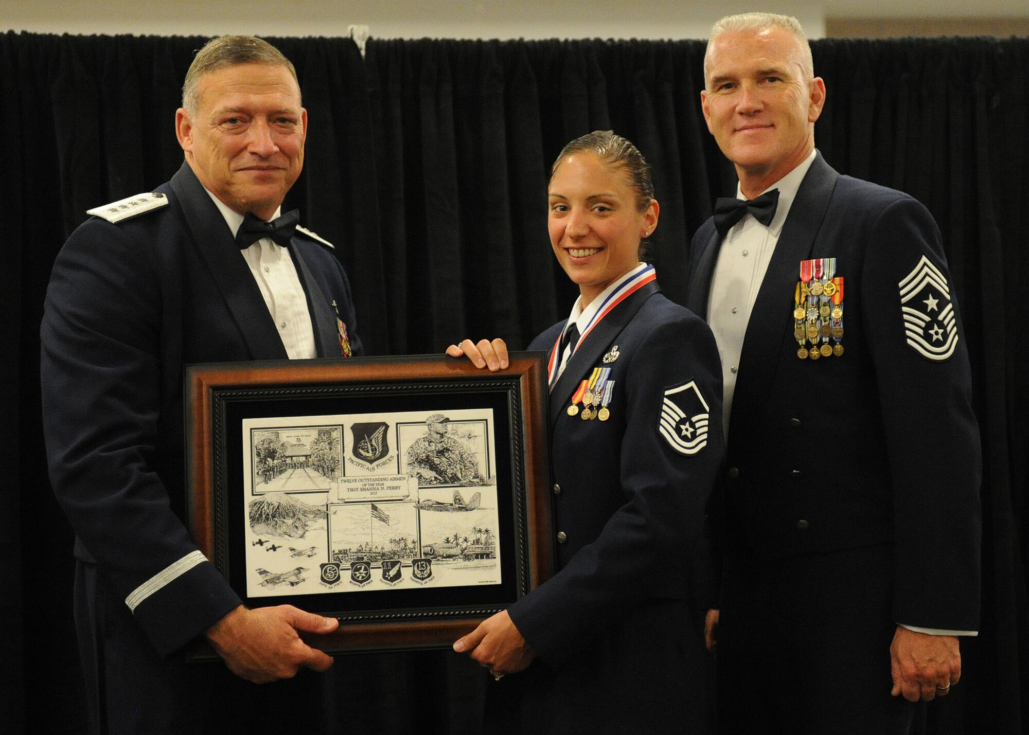 Pacific Air Forces commander Gen. Gary North and Chief Master Sgt. Brooke McLean, PACAF command chief, present Master Sgt. Shanna Perry, an education and training craftsman from the 477th Force Support Squadron, Joint Base Elmendorf-Richardson, Alaska, with PACAF Outstanding Airman of the Year honors at the Tradewinds Enlisted Club, Joint Base Pearl Harbor-Hickam, Hawaii, April 27, 2012. (U.S. Air Force photo/Tech. Sgt. Jerome S. Tayborn)