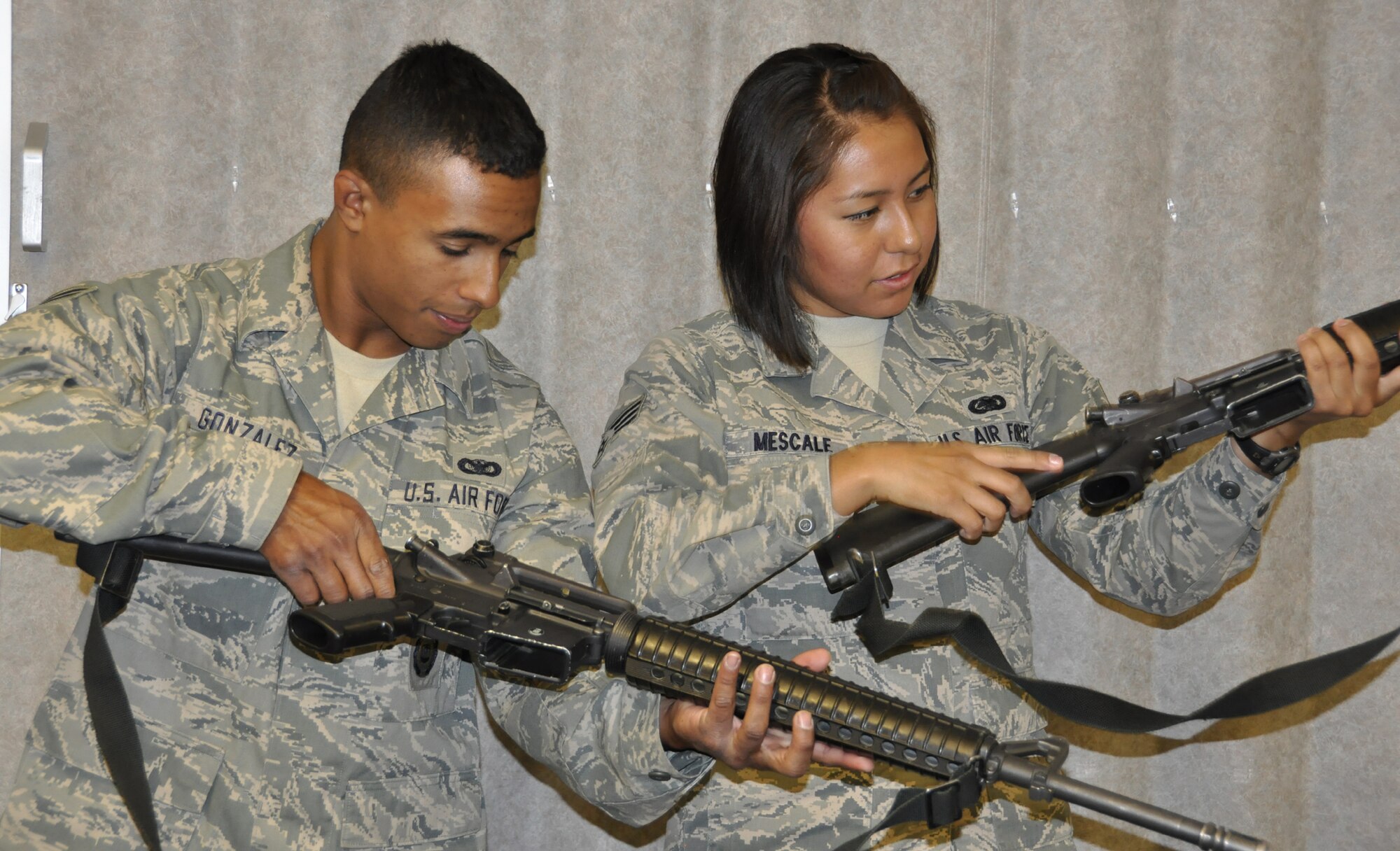 PETERSON AIR FORCE BASE, Colo. -- Senior Airman Carlos Gonzalez, combat arms instructor, 302nd Security Forces Squadron, shows Senior Airman Leandra Mescale, material management apprentice assigned to the 302nd Logistics Readiness Squadron, the steps to clear an M16 rifle. Besides weapons familiarization, Air Force Reservists from the 302nd AW attended litter carrying, post attack reconnaissance, door guard and facility manager training May 6, here to prepare for the wing's Operational Readiness Exercise which is scheduled to take place in June at Volk Field, Wis. (U.S. Air Force photo/Tech. Sgt. Daniel Butterfield) 