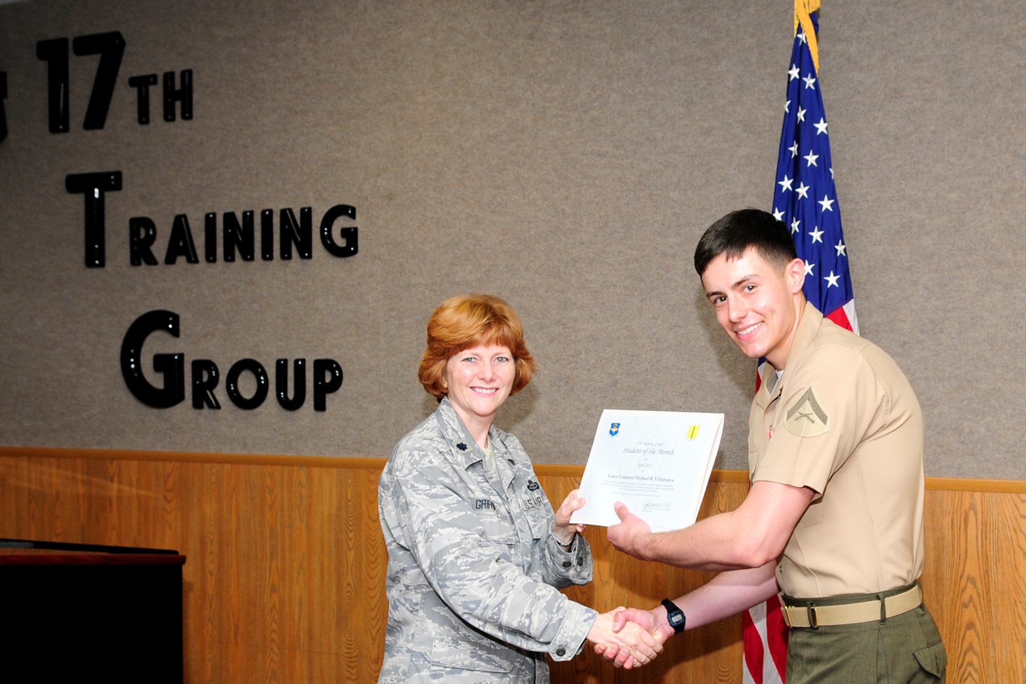 GOODFELLOW AIR FORCE BASE, Texas – Lt. Col. Patricia Griffin, 17th Training Group Deputy Commander, presents Marine Lance Cpl. Michael B. Villanueva with the 316th Training Squadron Student of the Month award for April, May 4. (U.S. Air Force photo/Staff Sgt. Austin Knox)