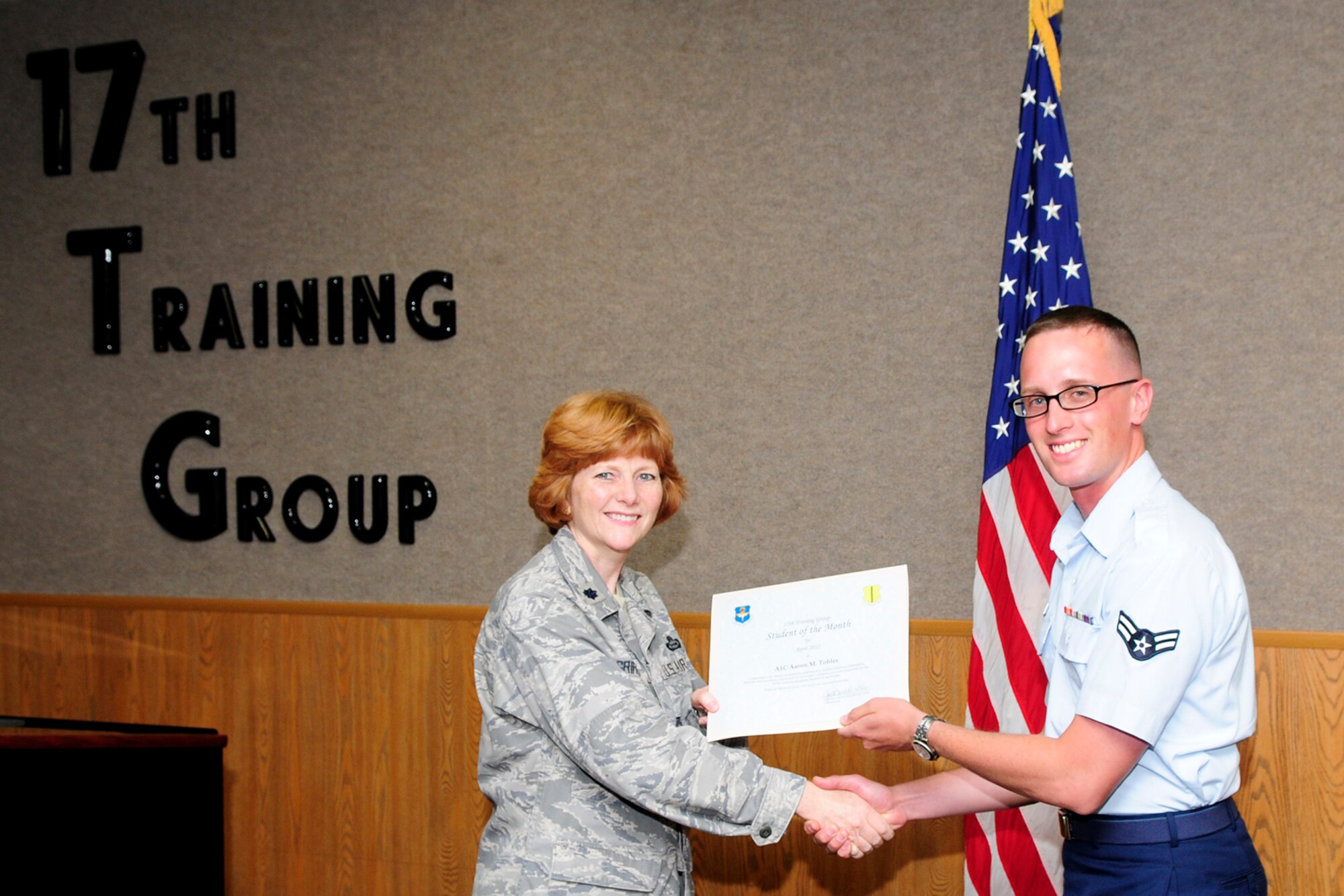 GOODFELLOW AIR FORCE BASE, Texas – Lt. Col. Patricia Griffin, 17th Training Group Deputy Commander, presents Airman 1st Class Aaron M. Tobler with the 315th Training Squadron Enlisted Student of the Month award for April, May 4. (U.S. Air Force photo/Staff Sgt. Austin Knox)