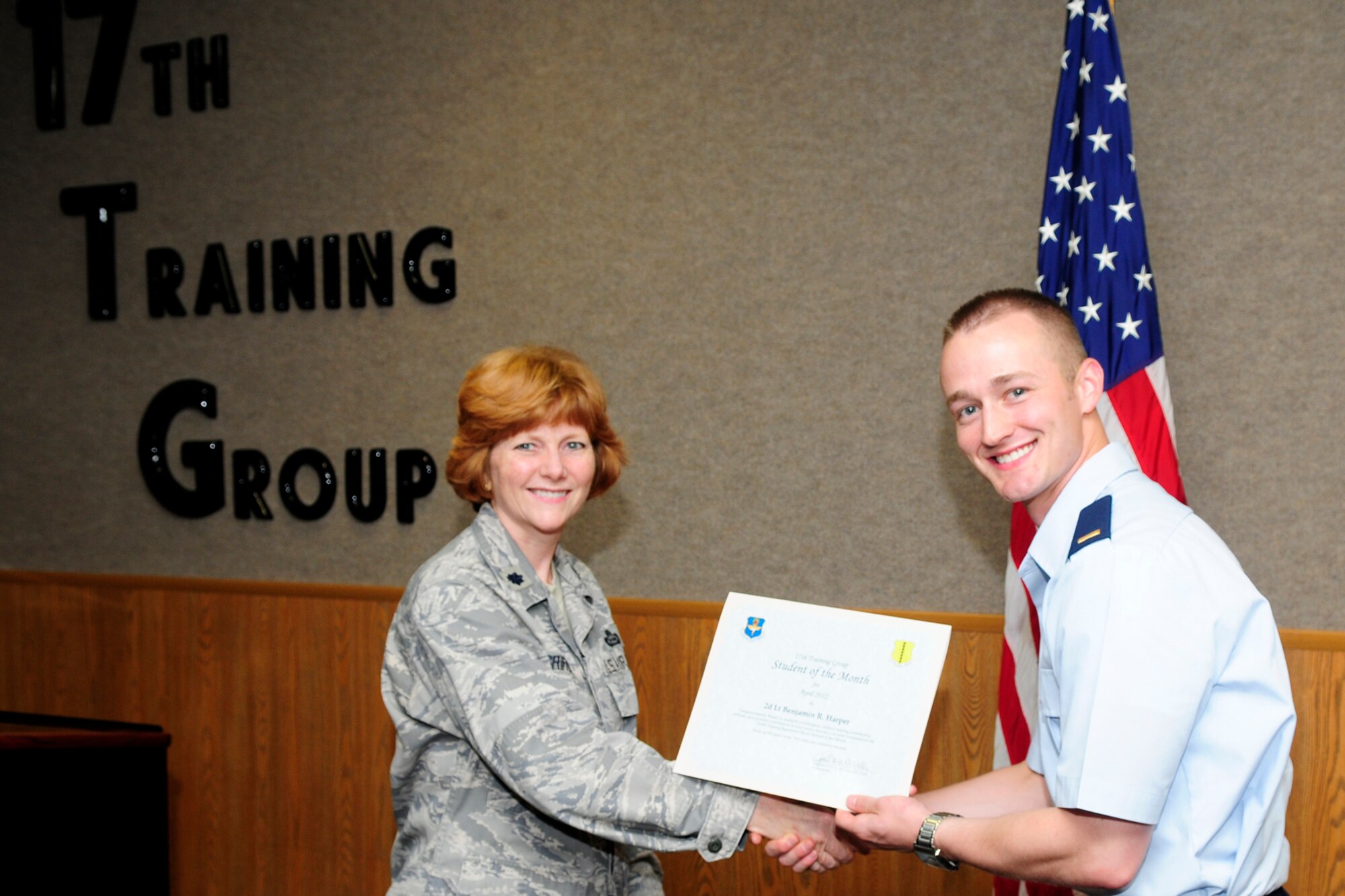 GOODFELLOW AIR FORCE BASE, Texas – Lt. Col. Patricia Griffin, 17th Training Group Deputy Commander, presents 2nd Lt. Benjamin R. Harper with the 315th Training Squadron Officer Student of the Month award for April, May 4. (U.S. Air Force photo/Staff Sgt. Austin Knox)
