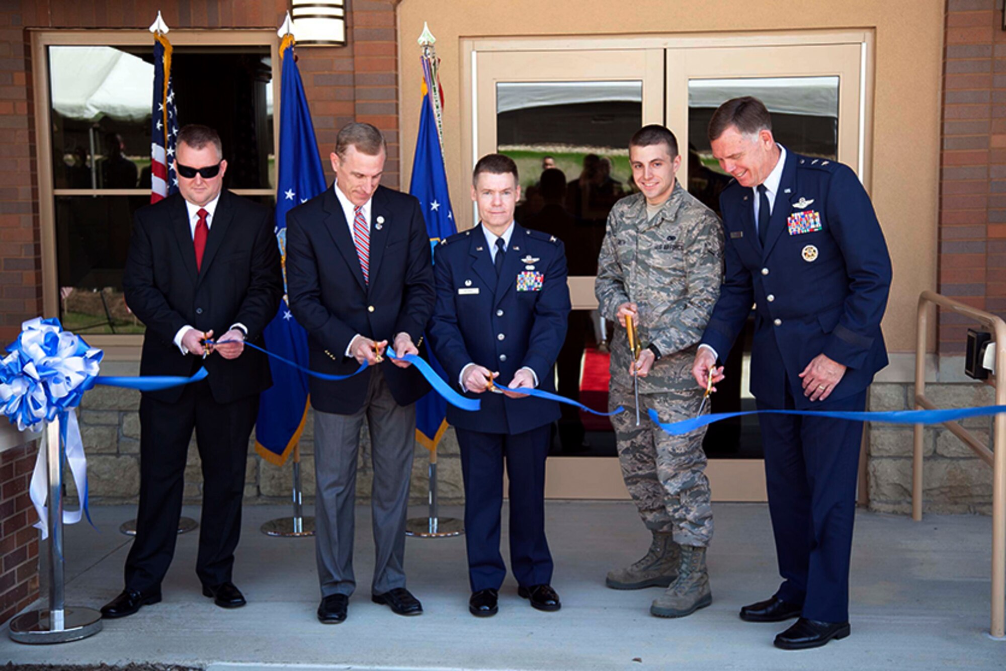 Military members and elected officials, from left, Jay Harris, project manager, Sota construction; Tim Murphy, representative, R-PA 18; Col. Craig C. Peters, commander, 911th Airlift Wing, William Smith, 911th Maintenance Squadron; Maj. Gen. Wallace “Wade” Farris, commander, 22nd Air Force,  cut the ceremonial ribbon in celebration of the base’s new lodging facility, building 226, May 6, 2012. The newly built lodging facility was erected in place of a pair of two-story buildings, which were built in 1952, making them among the oldest in the Air Force. The $ 8.5 million building holds 50 new rooms and will accommodate military members, DoD civilians and contractors. (U.S. Air Force photo by Tech. Sgt. Ralph Van Houtem/Released) (U.S. Air Force photo by Tech. Sgt. Ralph Van Houtem/ Released)

