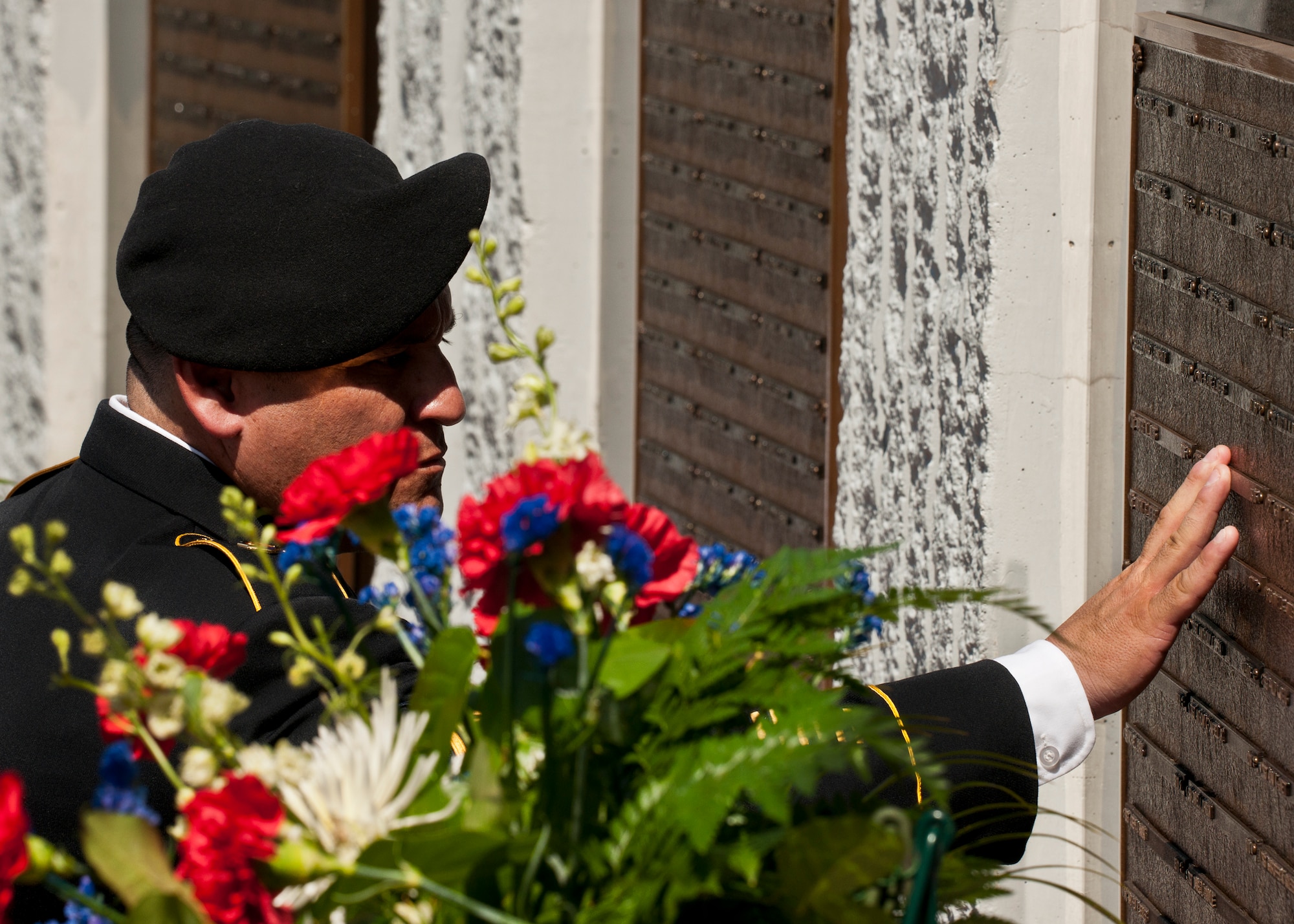 A Soldier touches the name of one of the fallen explosive ordnance disposal technicians listed on the memorial wall after the 43rd Annual EOD Memorial Ceremony May 5, 2012, at Eglin Air Force Base, Fla.  (U.S. Air Force photo/Samuel King Jr.)