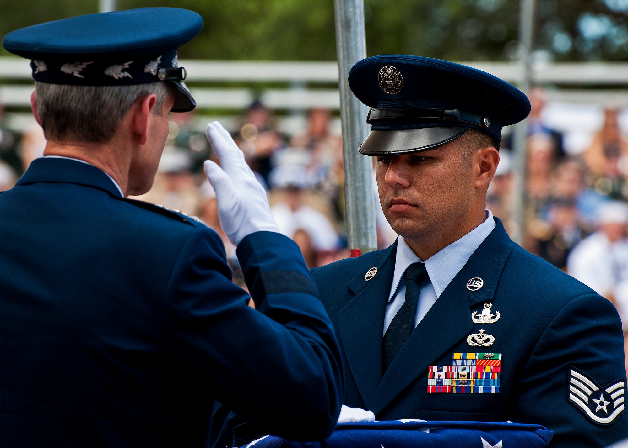 Air Force Chief of Staff Gen. Norton Schwartz salutes before taking a folded flag to a family member of a fallen explosive ordnance disposal Airman during the annual EOD Memorial Ceremony May 5, 2012, at Eglin Air Force Base, Fla. Schwartz was the guest speaker at the event that honored 18 EOD technicians, five of which were Airmen.  With the new names added, there are now 287 names inscribed on the memorial wall.  (U.S. Air Force photo/Samuel King Jr.)