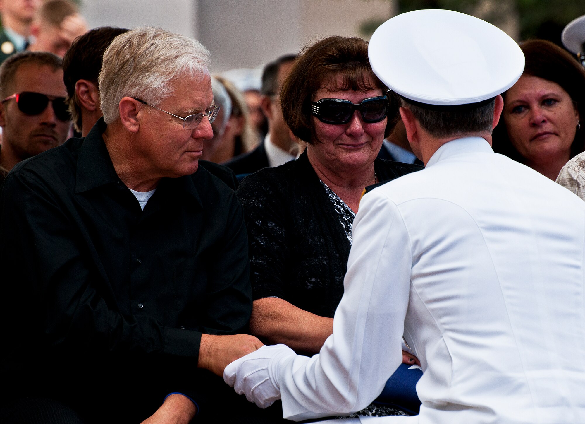 A Naval officer consoles the parents of Petty Officer 1st Class Chad Regelin, a fallen Navy explosive ordnance disposal technician, during the 43rd Annual EOD Memorial Ceremony May 5, 2012, at Eglin Air Force Base, Fla.  (U.S. Air Force photo/Samuel King Jr.)