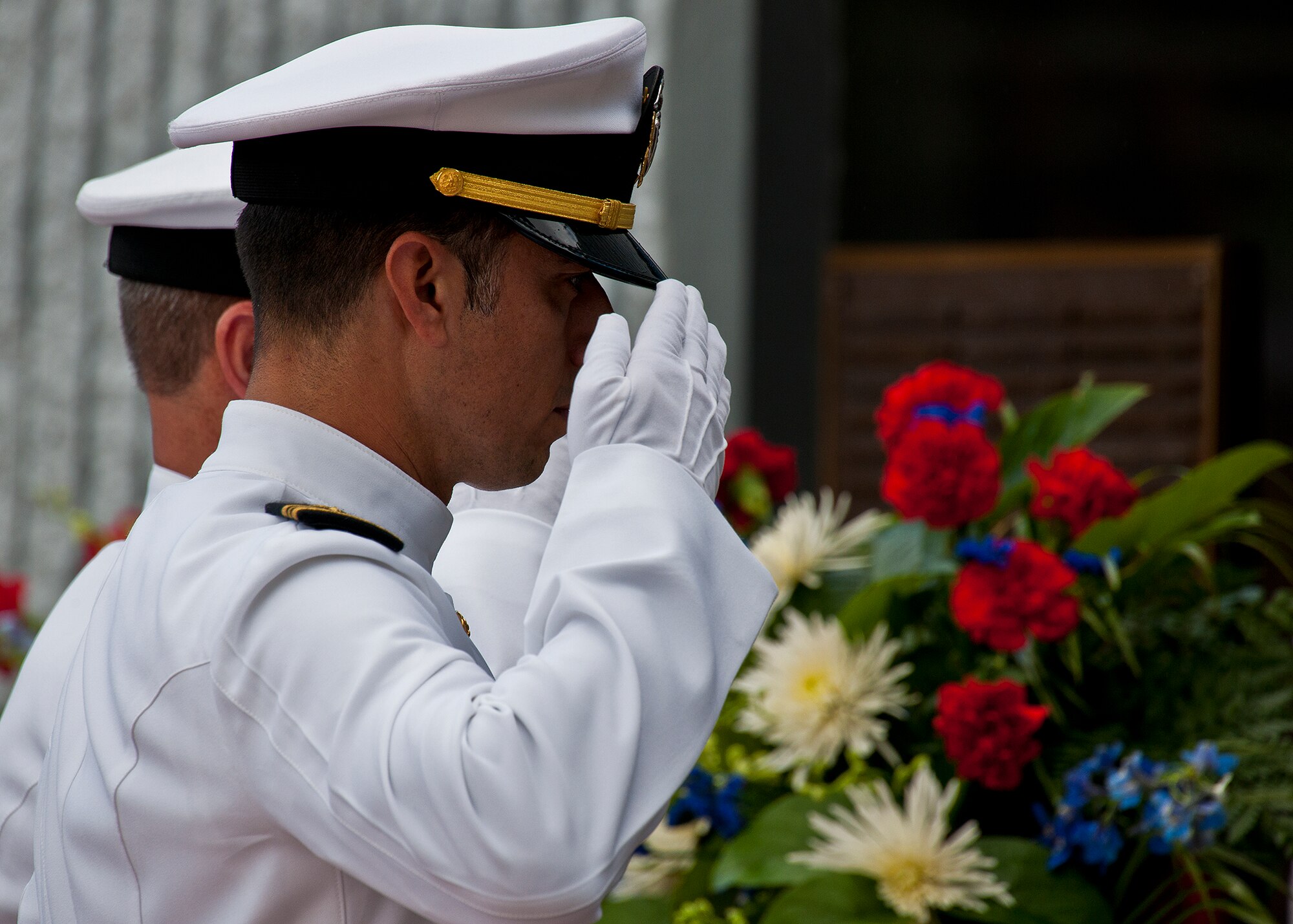 Lt. Cmdr. Rudy Schoen salutes the names of his fellow explosive ordnance disposal Sailors inscribed on the memorial wall during the 43rd Annual EOD Memorial Ceremony May 5, 2012, at Eglin Air Force Base, Fla.  (U.S. Air Force photo/Samuel King Jr.) 