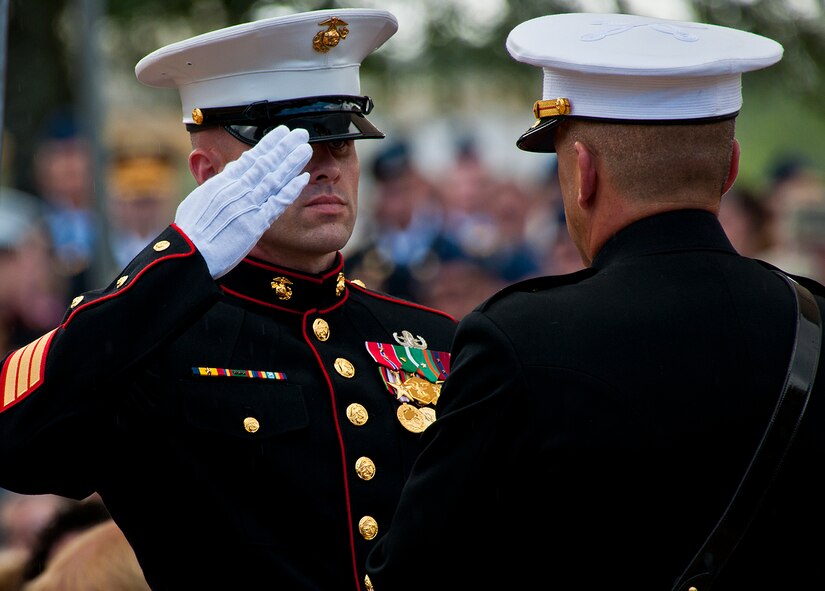 A Marine salutes after handing off a folded flag during the 43rd Annual EOD Memorial Ceremony May 5, 2012, at Eglin Air Force Base, Fla.  (U.S. Air Force photo/Samuel King Jr.)