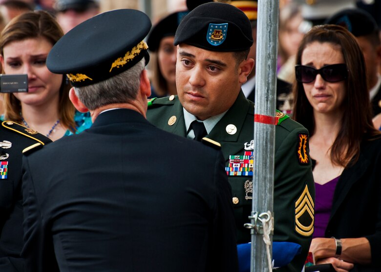Sergeant 1st Class Gonzales accepts a folded flag for his fellow Soldier, Staff Sgt. Michael Garcia, during the 43rd Annual EOD Memorial Ceremony May 5, 2012, at Eglin Air Force Base, Fla.  (U.S. Air Force photo/Samuel King Jr.)