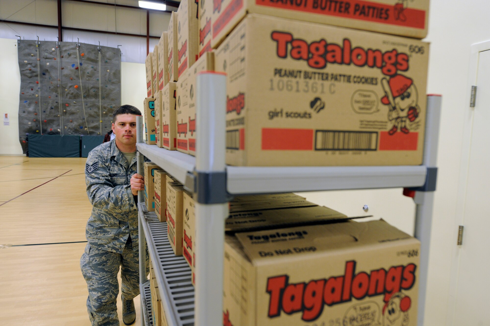 Staff Sgt. Michael Gump, 92nd Force Support Squadron manpower journeyman, pushes a cart of Girl Scout cookies at the Girl Scouts of Eastern Washington and Idaho building in Spokane, Wash., May 1, 2012. Girl Scouts of Eastern Washington and Idaho donated approximately 500 crates of cookies to servicemembers at Fairchild Air Force Base, Wash. (U.S. Air Force photo by Airman 1st Class Ryan Zeski/Released)