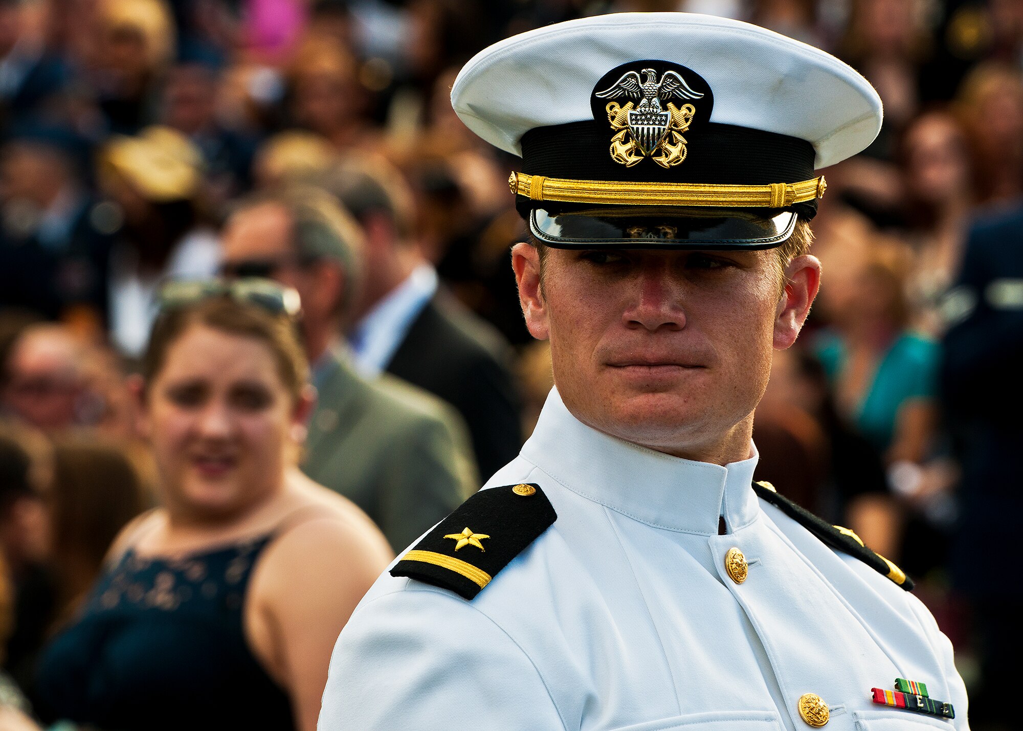 A sailor hands out programs before the 43rd Annual EOD Memorial Ceremony May 5, 2012, at Eglin Air Force Base, Fla.  (U.S. Air Force photo/Samuel King Jr.)