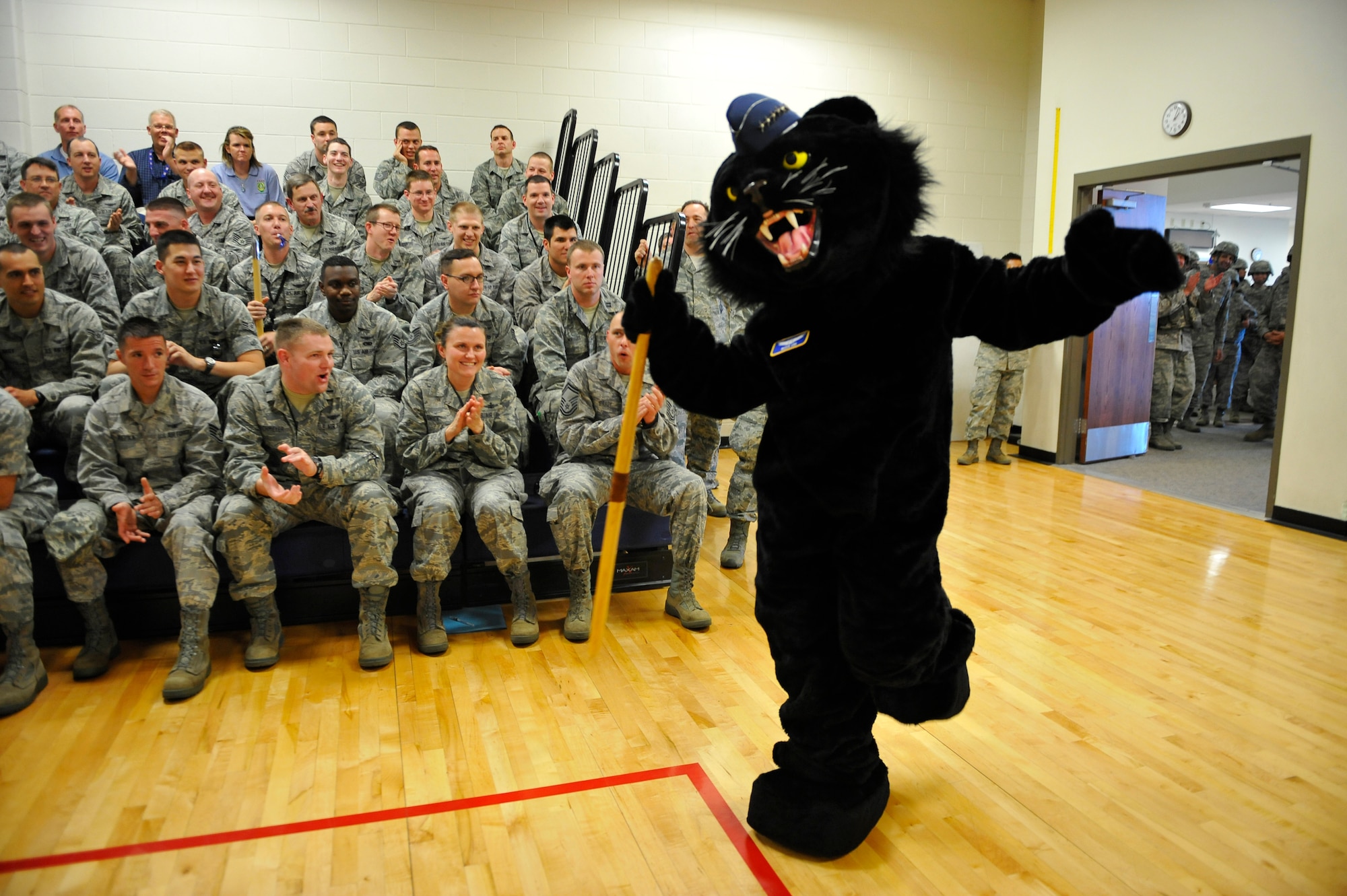 BUCKLEY AIR FORCE BASE, Colo. – Panther “General Buck Lee,” 460th Space Wing mascot, dances his way into the Buckley Fitness Center gym May 4, 2012, to kick off a commander’s call. Hundreds of Airmen rallied into the gym to review expectations of the upcoming Operational Readiness Inspection, which is scheduled for May 11-22. (U.S. Air Force photo by Staff Sgt. Kathrine McDowell)
