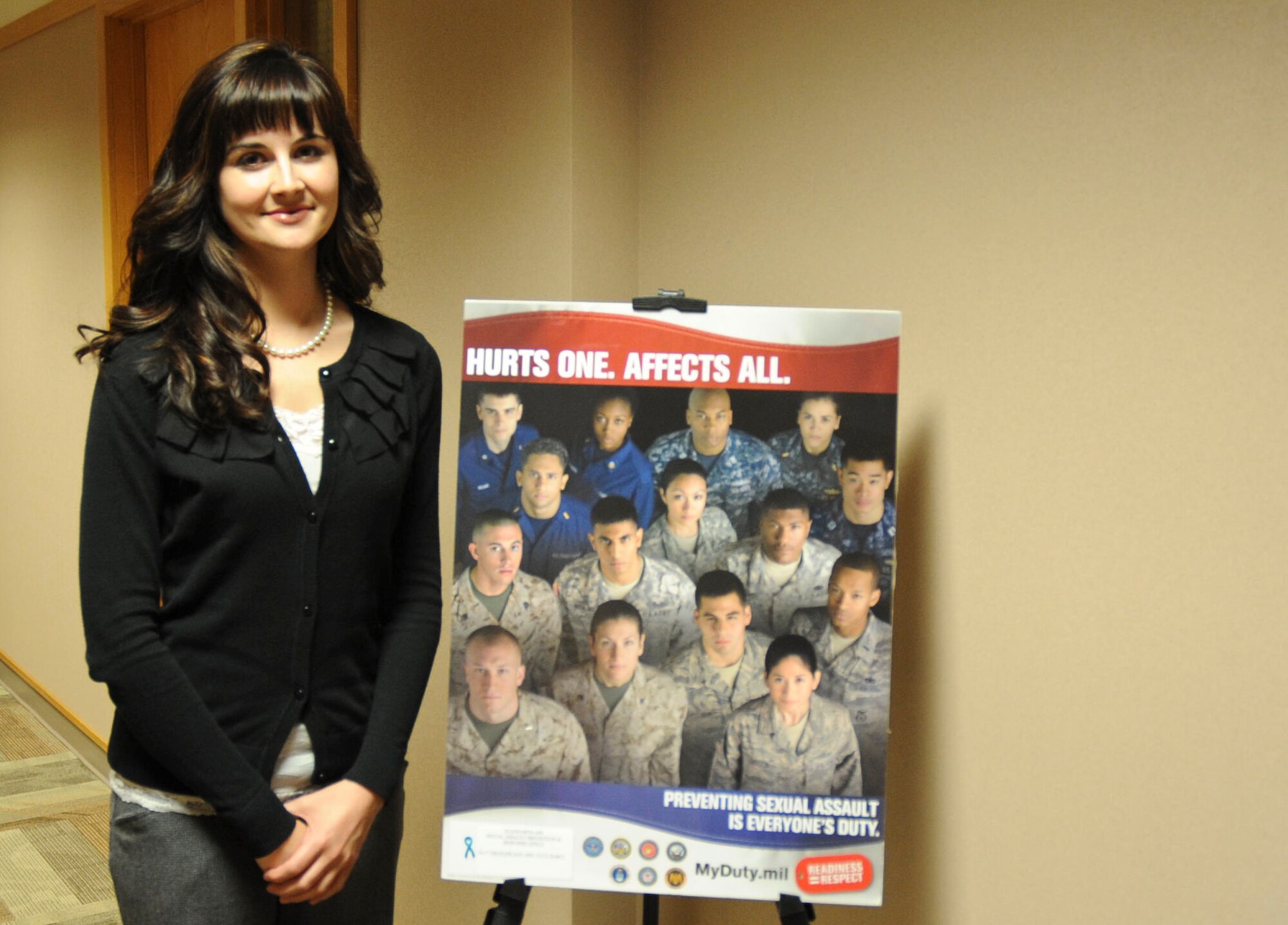 Ellsworth’s new Sexual Assault Responder coordinator, Kelly Dominguez, stands by a sexual assault prevention poster at the Rushmore Center on Ellsworth Air Force Base, S.D., April 23, 2012. In support of April being sexual assault awareness month, the SARC office has displayed posters and set up tables throughout the base informing Airmen about sexual assault awareness and prevention. (U.S. Air Force photo by Airman 1st Class Anania Tekurio/Released) 