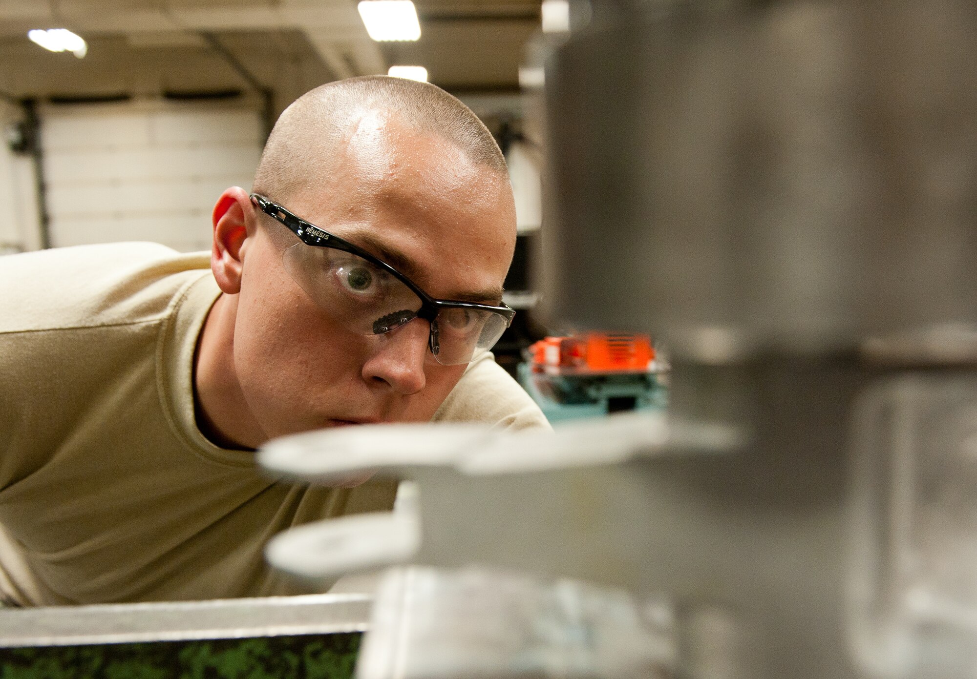 Airman 1st Class Justin Morris, 28th Maintenance Squadron metals technology apprentice, installs a bushing into a new bell crank housing using an arbor press in the metals technology shop at Ellsworth Air Force Base, S.D., May 2, 2012. Once the part is complete, it will be sent to the 28th Munitions Squadron, where Airmen there will use it for realistic training on munitions loading equipment. (U.S. Air Force photo by Airman 1st Class Kate Thornton/Released)
