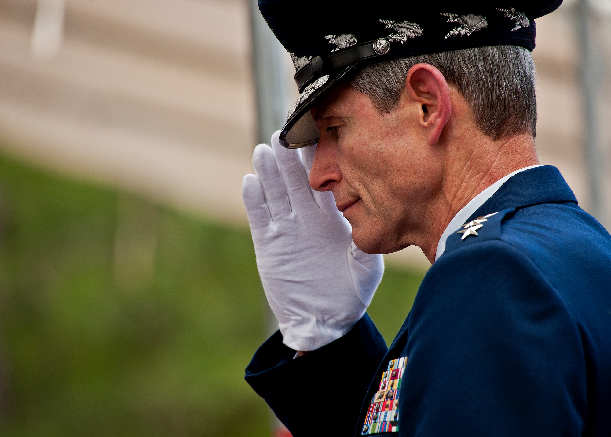 Air Force Chief of Staff Gen. Norton Schwartz salutes a family member of a fallen explosive ordnance disposal Airman during the annual EOD Memorial Ceremony May 5, 2012, at Eglin Air Force Base, Fla. Schwartz was the guest speaker at the event that honored 18 EOD technicians, five of which were Airmen.  With the new names added, there are now 287 names inscribed on the memorial wall.  (U.S. Air Force photo/Samuel King Jr.)