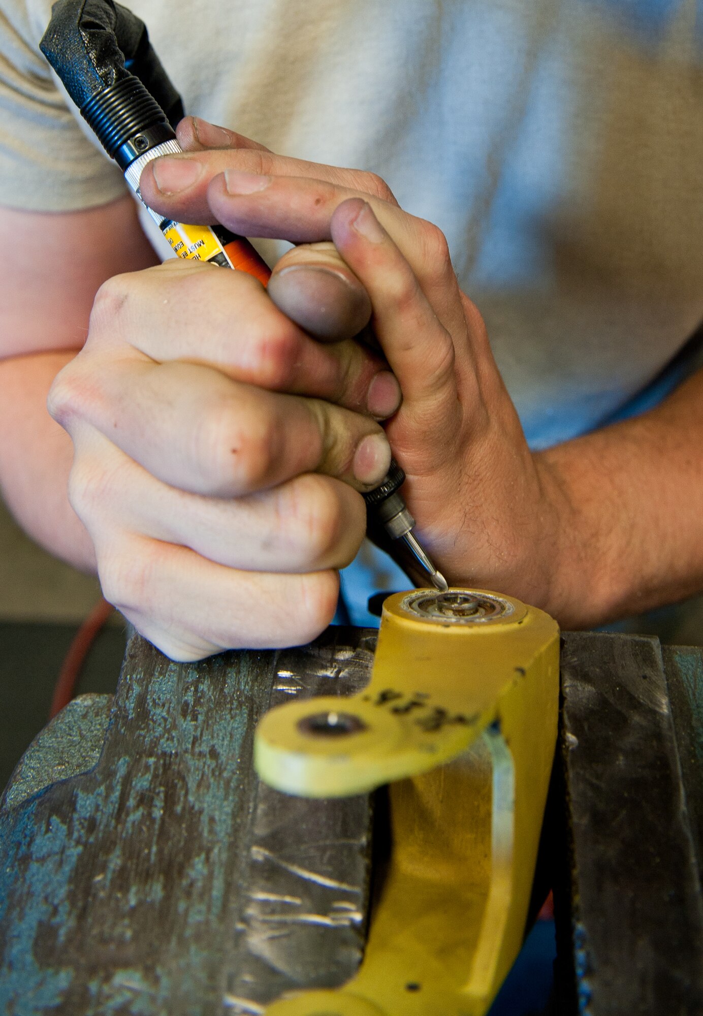 Airman 1st Class Justin Morris, 28th Maintenance Squadron metals technology apprentice, cuts away metal on an unserviceable B-1 bomber bell crank housing and replaces it with a new one in the metals technology shop at Ellsworth Air Force Base, S.D., May 2, 2012. Metals technology technicians are trained to perform a variety of manufacturing and repairing skills to ensure equipment remains serviceable and operates correctly. (U.S. Air Force photo by Airman 1st Class Kate Thornton/Released) 